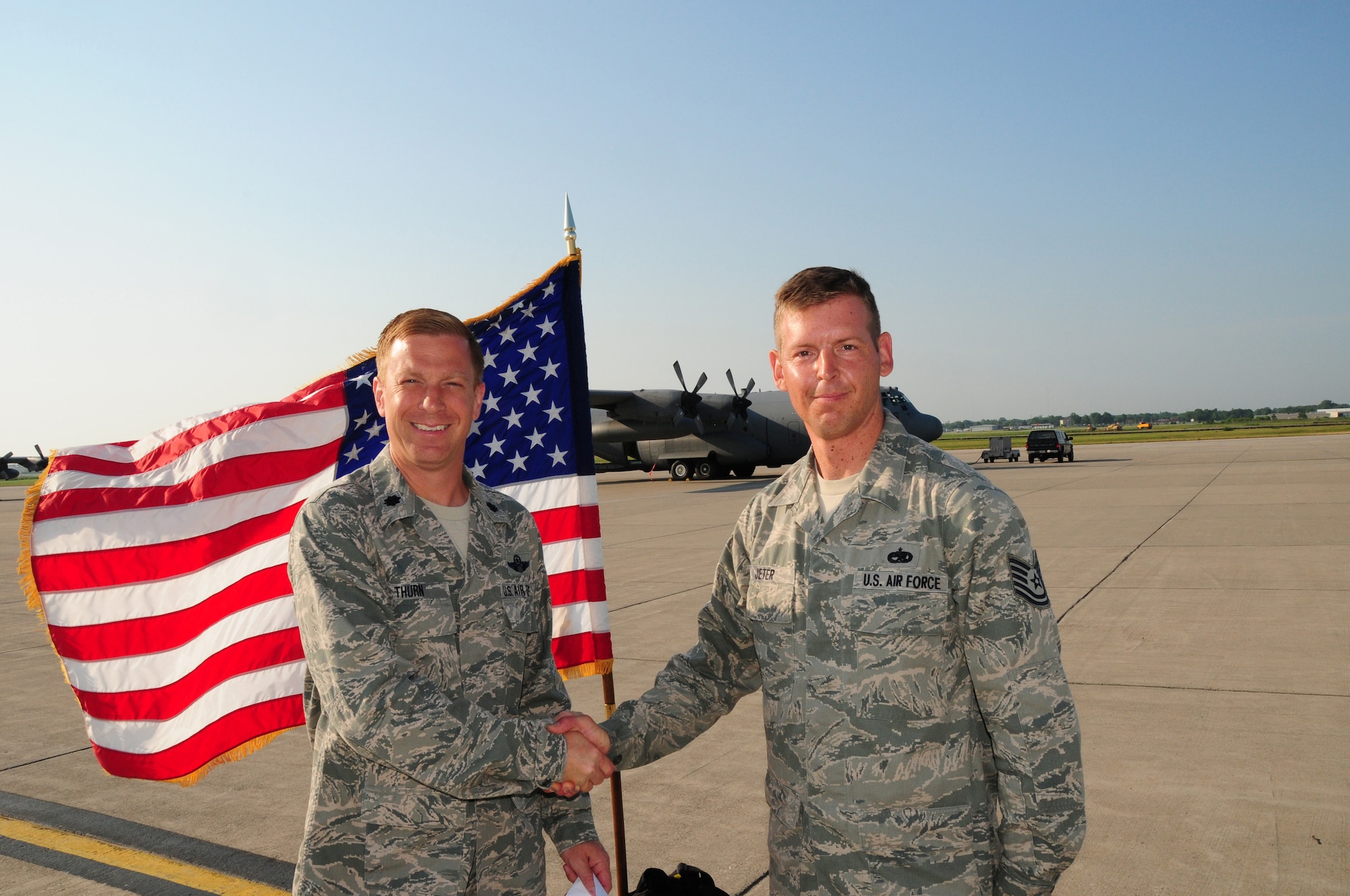 Lt. Col. Christopher Thurn, 107th Airlift Wing's Maintenance Squadron Commander congratulates Tech. Sgt. Roman Jeter, C-130 Aircraft Crew Chief for reenlisting for six more years with the 107th Airlift Wing on June 20, 2012. (U. S. Air Force Photo/Senior Master Sgt. Ray Lloyd)