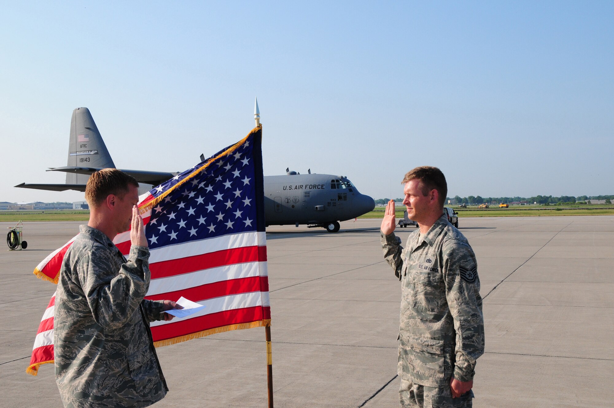 Tech. Sgt. Roman Jeter, C-130 Aircraft Crew Chief reenlists for six more years with the 107th Airlift Wing. Lt. Col. Christopher Thurn, 107th Airlift Wing's Maintenance Squadron Commander, performed the reenlistment oath on June 20, 2012. (U. S. Air Force Photo/Senior Master Sgt. Ray Lloyd)