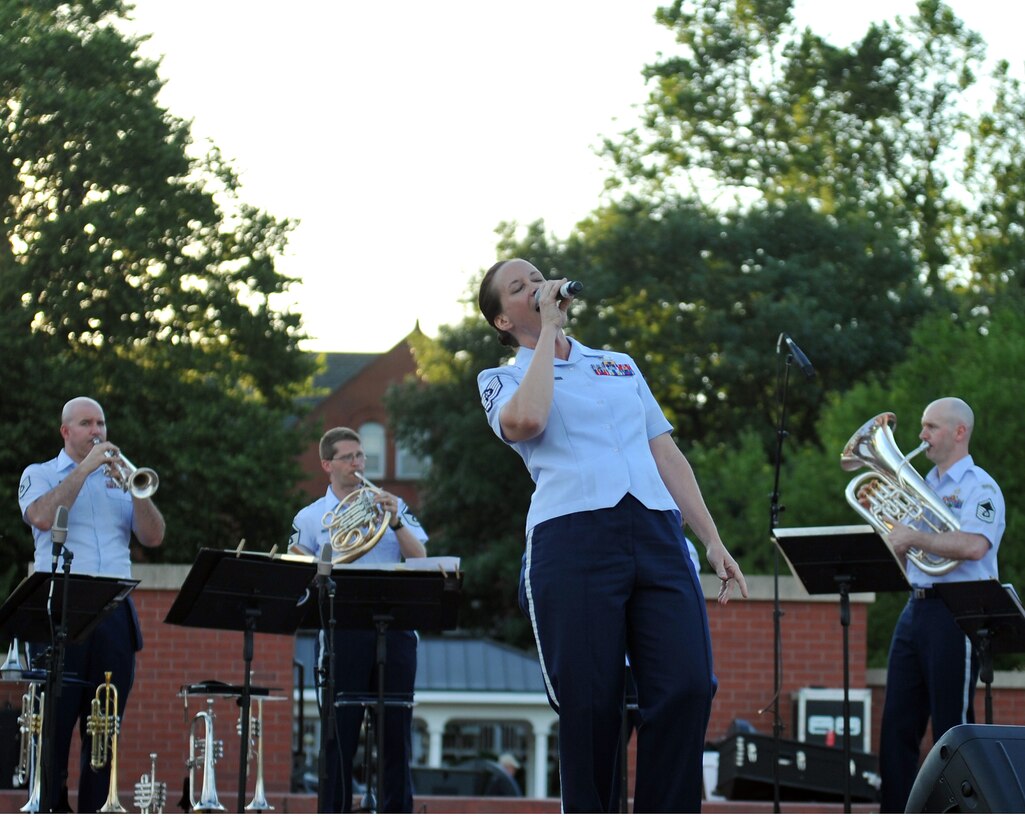 Technical Sergeant Rebecca Packard, vocalist with Brass in Blue, performs at the Offutt Air Force Base Parade Field - part of the Heartland of America Band's "Sunday's on Parade" concert series.