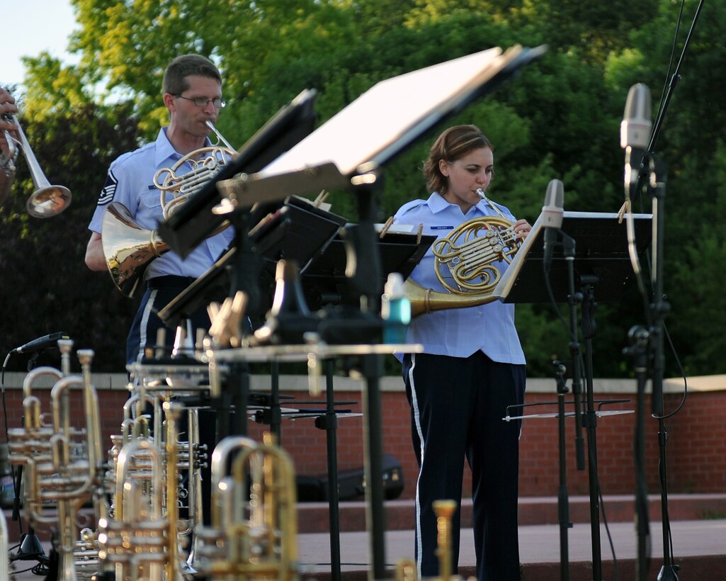 French Hornists Master Sergeant Ryan Heseltine and Airman First Class Alena Zidlicky perform with Brass in Blue - part of the Heartland of America Band's "Sunday's on Parade" concert series on the Offutt Air Force Base Parade Field.