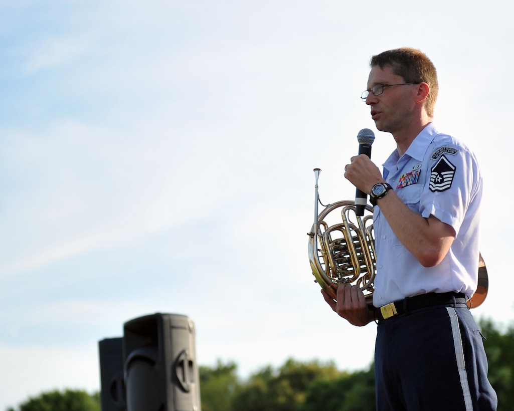 Master Sergeant Ryan Heseltine, Noncommissioned Officer in Charge of Brass in Blue, addresses the audience at a performance on the Offutt Air Force Base Parade Field - part of the Heartland of America Band's "Sunday's on Parade" concert series 