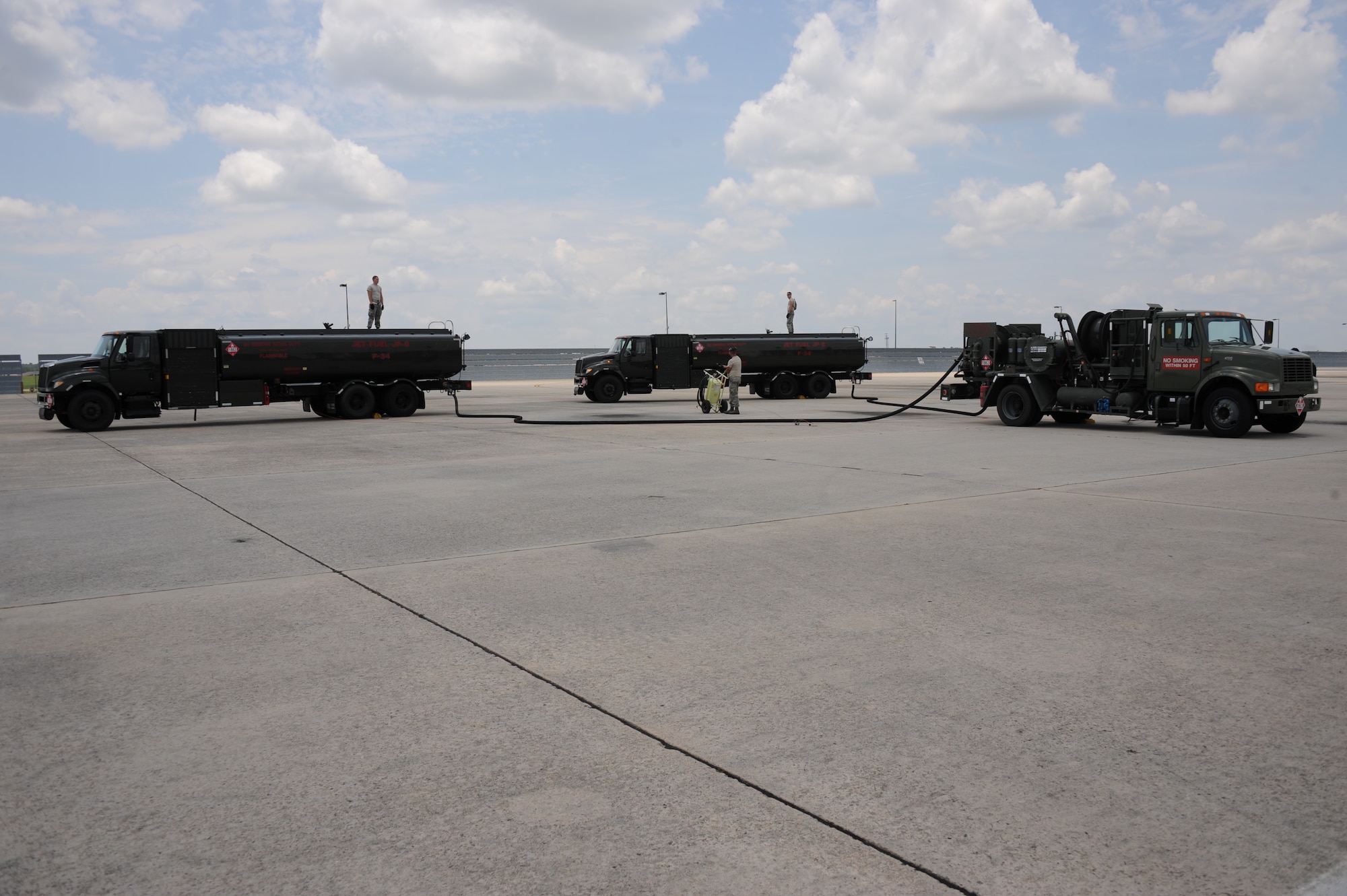 Fuel trucks from the Joint STARS 116th Logistics Readiness Flight petroleum, fuels, and oils (POL) section, perform a modified hot-pit procedure at Robins Air Force Base, Ga., June 14, 2012.  The POL section was participating in exercise Iron Dagger 2012.  During the procedure, Airmen from the 116th POL section worked with Airmen from the 4th Logistics Readiness Squadron from Seymour Johnson Air Force Base, N.C. to rapidly refuel F-15E Strike Eagles from the 4th Fighter Wing that were flying in the exercise.  (National Guard photo by Master Sgt. Roger Parsons/Released)