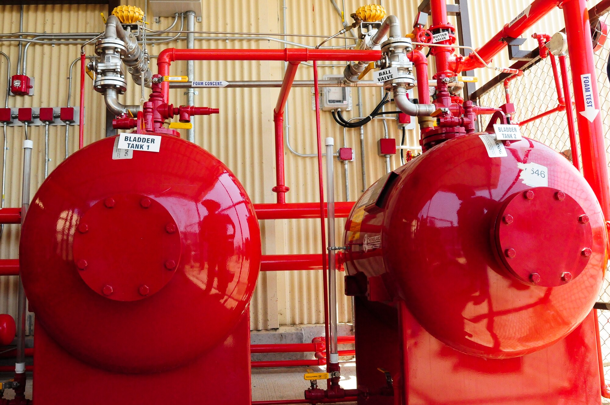Officials from the 39th Civil Engineer Squadron and several contracted companies conduct the final certification and test of the new fire suppression system for the 414th Expeditionary Reconnaissance Squadron hangar June 15, 2012, at Incirlik Air Base, Turkey. The $250,000 system protects $12 million of equipment from fire damage by extinguishing flames with fire suppressant foam in less than four minutes. The final test indicated that the fire suppressant foam surpassed the designated 4-minute height requirement in only 50 seconds. (U.S. Air Force photo by Capt. Gina McKeen/Released)