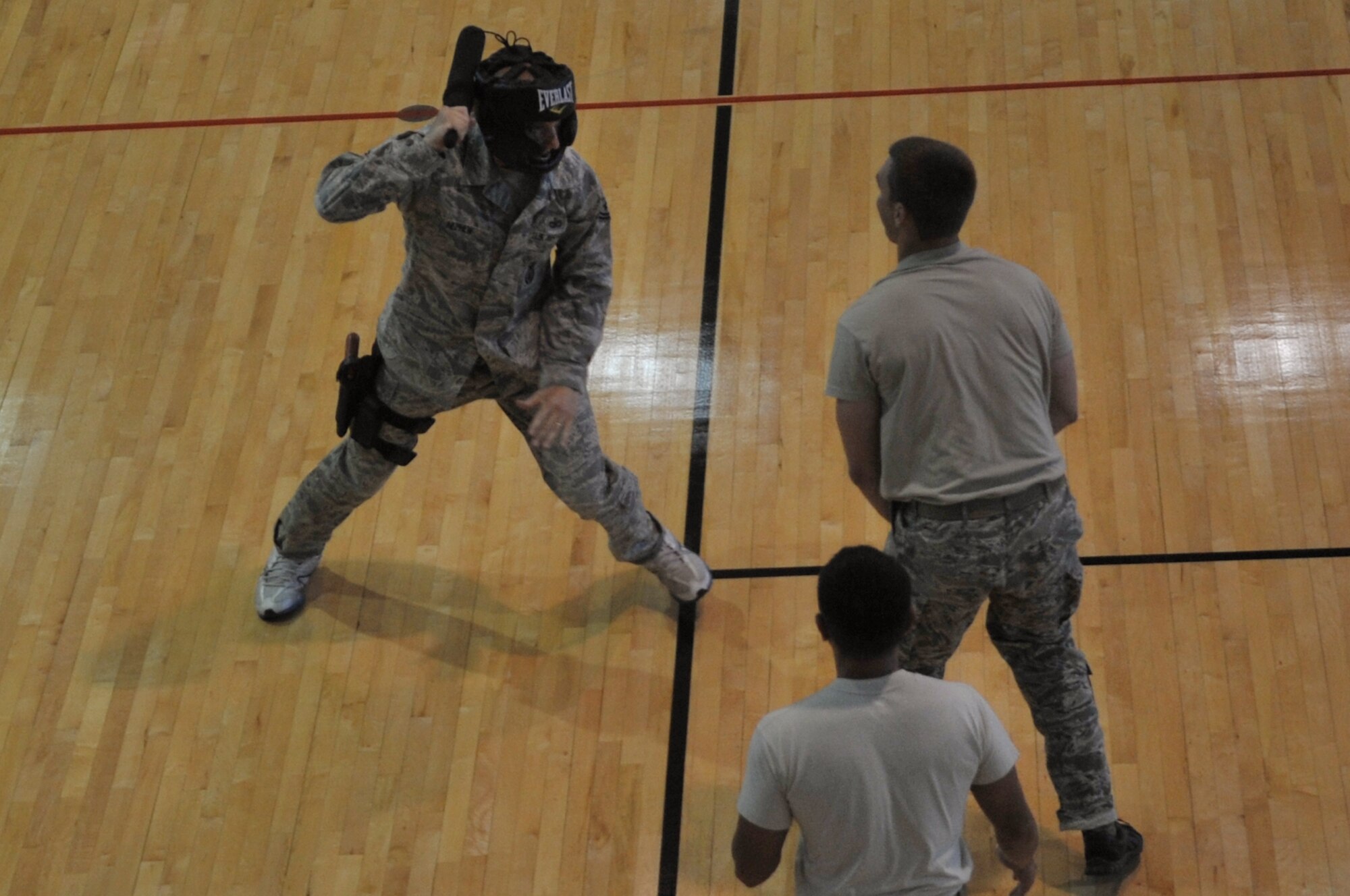 Tech. Sgt. James Nephew (left) squares off against Staff Sgt. Perry Vitali during baton training at the Osan Air Base fitness center, June 19, 2012. The 51st Security Forces Squadron holds baton training once a month where they will go through various muscle memory drills to become baton qualified. Nephew and Vitali belong to the 51st SFS. (U.S. Air Force photo/Staff Sgt. Craig Cisek)