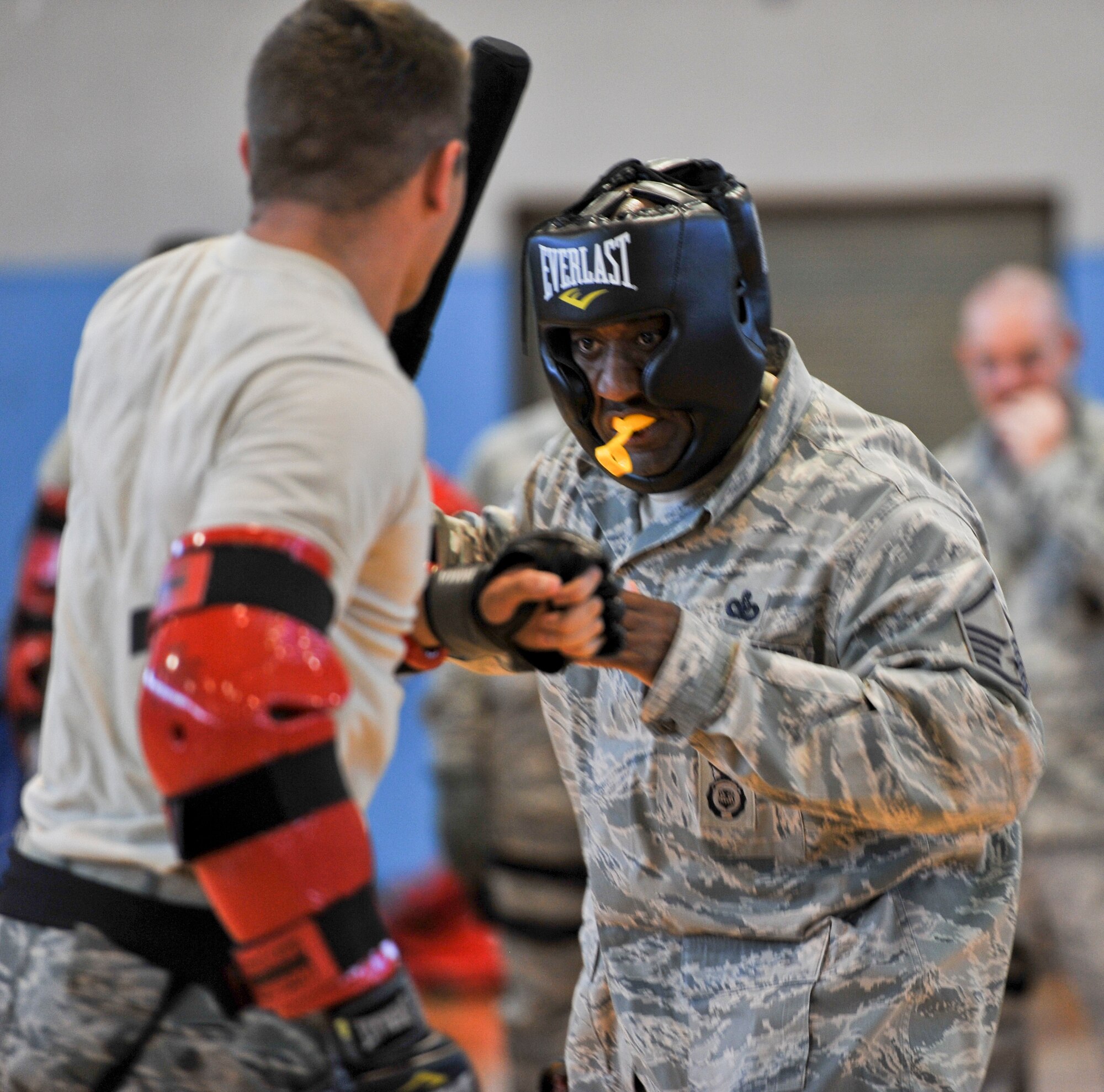 Master Sgt. Joseph Dockery III, prepares to use non-lethal force to control an adversary during a baton training class at the Osan Air Base fitness center, June 19, 2012. The 51st Security Forces Squadron holds baton training once a month which consists of various muscle memory skills to help Airmen to become baton certified. Airmen put their skills to the test during a quick fighting match with other security forces Airmen to help them understand the situations they may face that require them to use non-lethal force.(U.S. Air Force photo/Staff Sgt. Stefanie Torres)