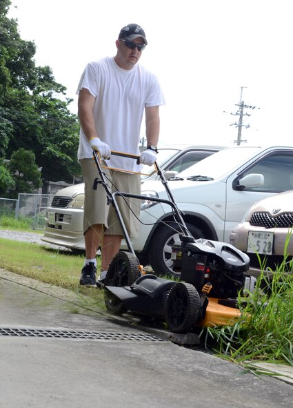 U.S. Air Force Tech. Sgt. Bobby Warminsky, Henry E. Erwin Professional Military Education Center Class 12-05 student, mows a patch of weeds at the Ichijoen Elders Home June 16, 2012. Twenty seven members of Class 12-05 visited the elder’s home for an afternoon of lawn work during a volunteer community relations activity. Warminsky is a member of the 36th Communications Squadron Anderson Air Force Base, Guam. (U.S. Air Force photo by Tech. Sgt. Phillip Butterfield/Released) 
