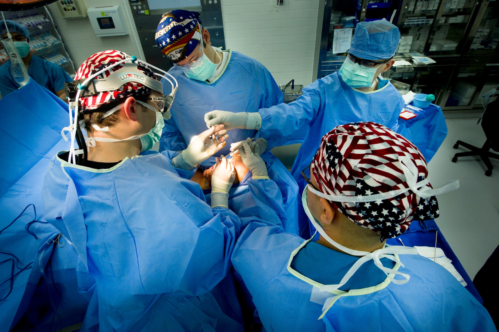 YOKOTA AIR BASE, Japan -- A surgical crew secures cartilage grafts on Staff Sgt. Flor Rocha's during a rhinoplasty operation at Yokota Air Base, Japan, June 11, 2012. This six-hour  procedure uses harvested cartilage from Rocha's ribs to reconstruct the shape of her nose to correct a breathing problem. (U.S. Air Force Photo by Staff Sgt. Stacy Moless)