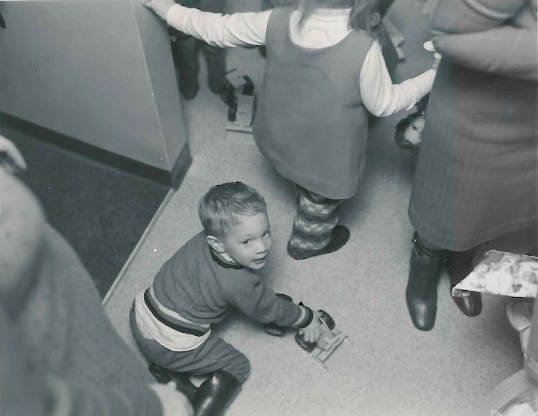 Child plays with Christmas gift.