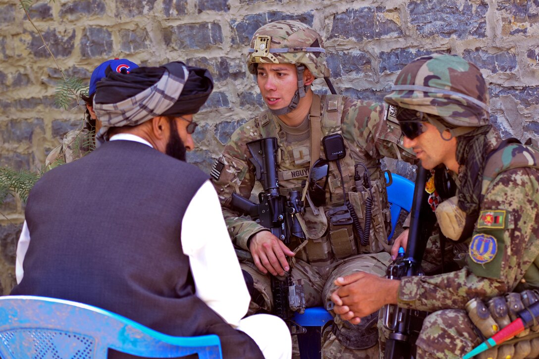 U.S. Army 1st Lt. Patrick Nguyen talks with a village elder during a key leader engagement in the Terezayi district, Afghanistan, June 8, 2012. Nguyen, a platoon leader, is assigned to 1st Battalion, 501st Infantry Regiment. During key leader engagements, coalition forces try to find ways to work with local populations and strengthen trust.