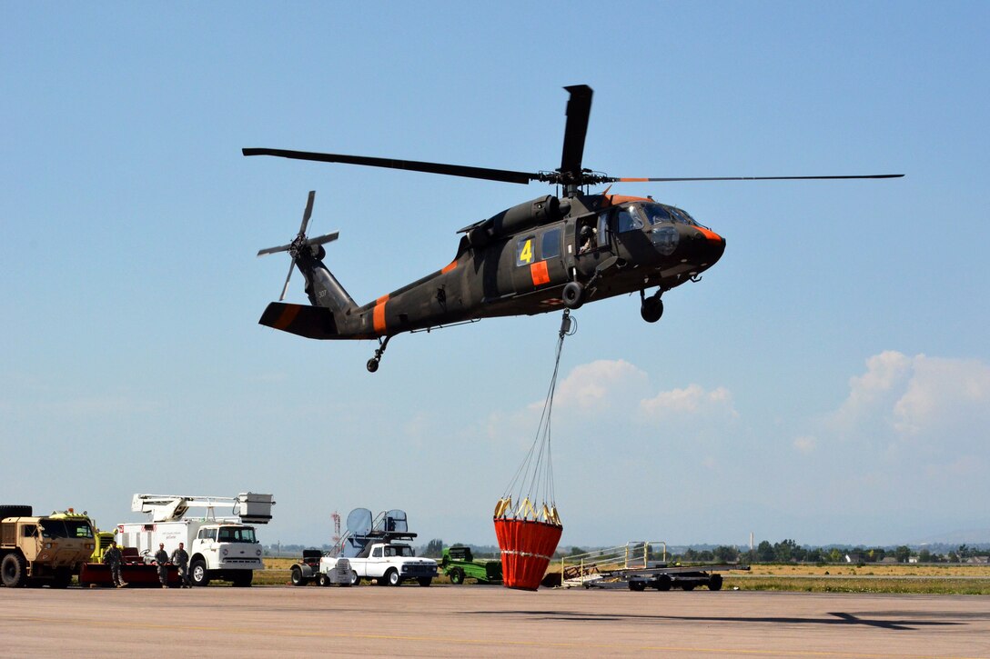 Soldiers in a UH-60 Black Hawk helicopter take off from Fort Collins-Loveland Municipal Airport near Loveland, Colo., June 15, 2012. They conducted a bucket mission to help fight the High Park wildfire about 15 miles northwest of Fort Collins.