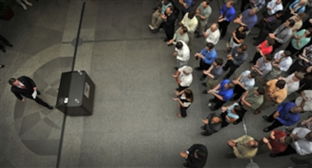 Deputy Secretary of Defense Ashton B. Carter approaches the lectern to addresses employees at Space and Naval Warfare Systems Command Headquarters during a visit to Joint Base Charleston in Charleston, S.C., June 18, 2012.  