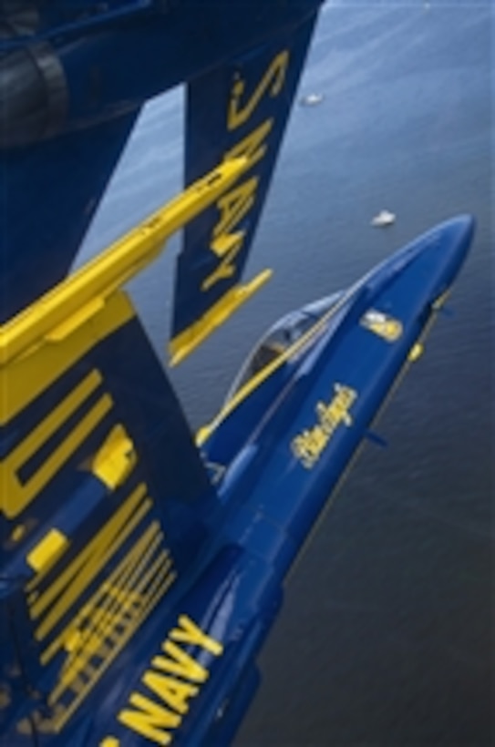 Capt. Brandon Cordill, left wingman of the U.S. Navy flight demonstration squadron, the Blue Angels, flies with the canopy of his F/A-18 Hornet approximately 18 inches from the wingtip of Capt. Greg McWherter during the “diamond 360” maneuver over Baltimore's Inner Harbor on June 15, 2012.  The Blue Angels performed during the Star Spangled Sailabration as part of Baltimore Fleet Week 2012.  DoD photo by Petty Officer 2nd Class Andrew Johnson, U.S. Navy.  