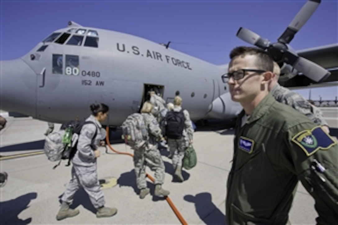 U.S. Air Force Senior Airman Christian Cattell conducts a head count of airmen boarding a C-130H Hercules aircraft at Reno-Tahoe International Airport, Nev., on June 15, 2012, during exercise Global Medic 2012.  Global Medic is a joint U.S. Air Force Reserve-U.S. Army Reserve field training exercise for theater aero-medical evacuation systems and ground medical components. Cattell is a loadmaster with the 192nd Airlift Squadron, Nevada Air National Guard. 