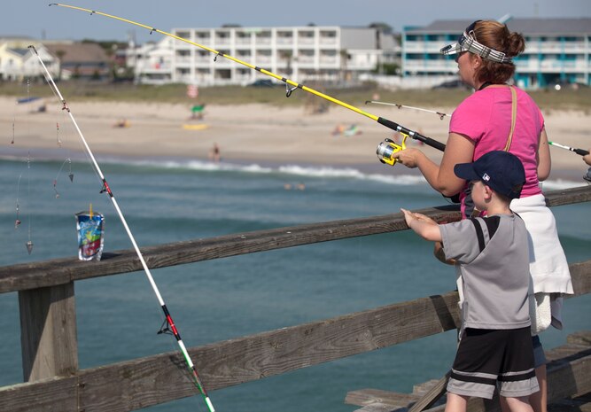 A mother and her child fish off the edge of the Kure Beach fishing pier during the Step Up For Soldiers’ Children’s Fishing Tournament at Kure Beach June 9. The tournament was free for all who participated, and everything needed was provided by SUFS. 