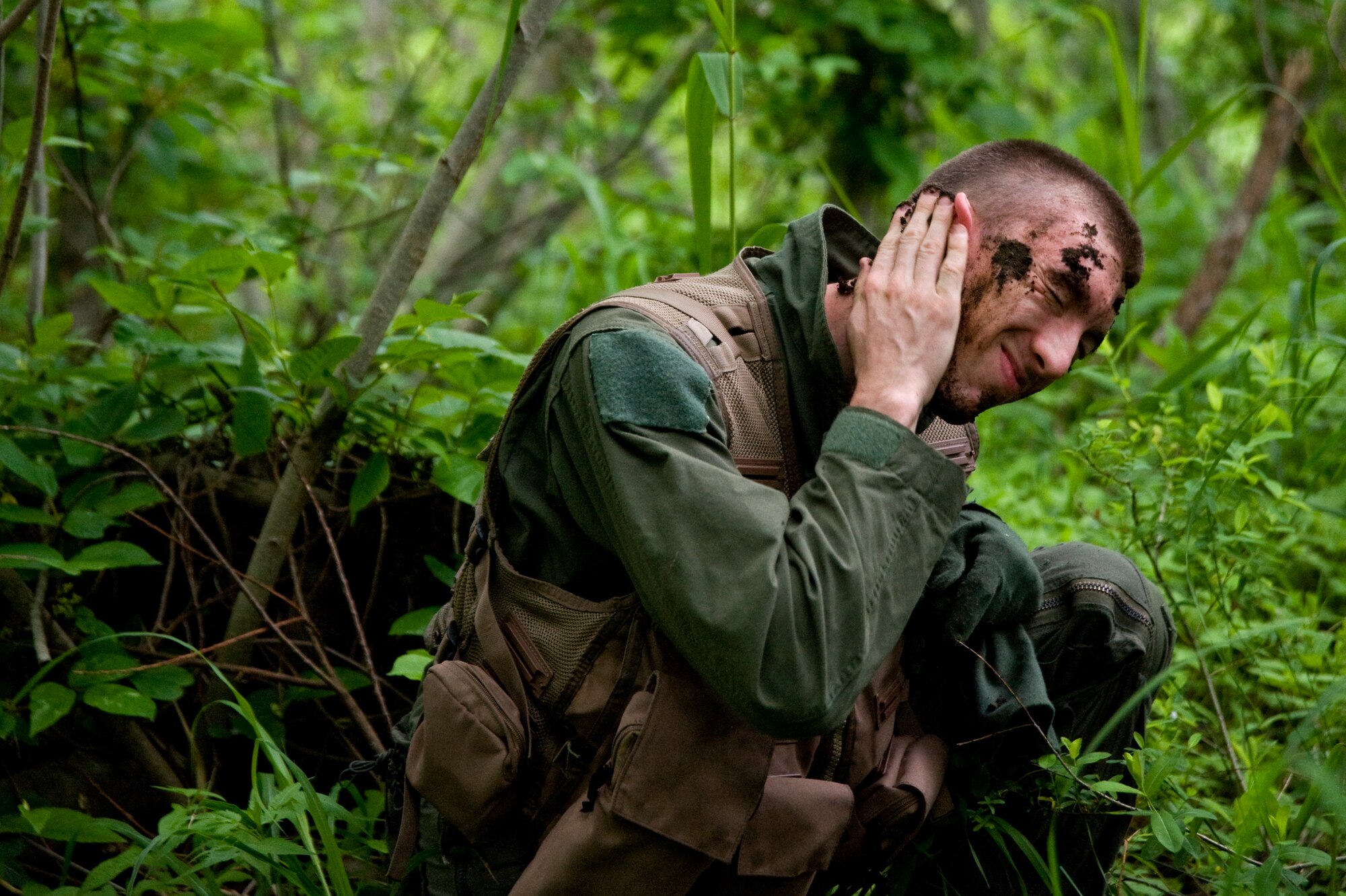 U.S. Air Force Senior Airman Michael Dixon, 35th Operations Support Squadron survival, evasion, resistance and escape specialist, uses dirt to camouflage his face during SERE training at Draughon Range, Japan, June 20, 2012. Blending in with the surroundings increases personnel’s chances of evading capture while isolated. (U.S. Air Force photo by Staff Sgt. Nathan Lipscomb/Released)