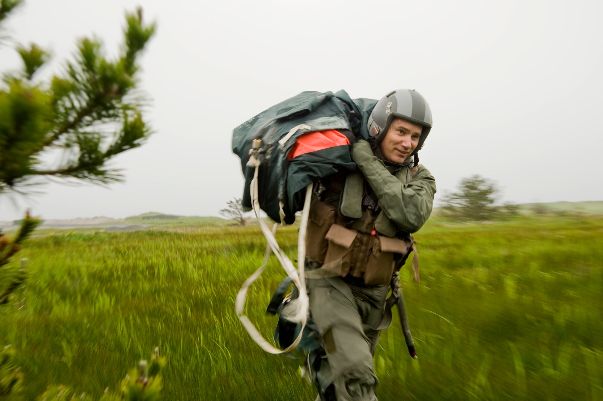U.S. Air Force Chief Master Sgt. James Laurent, 35th Fighter Wing command chief, runs for cover during Survival, Evasion, Resistance and Escape training at Draughon Range, Japan, June 20, 2012. SERE specialists spent the day and part of the night training Air Force personnel to survive and evade capture. (U.S. Air Force photo by Staff Sgt. Nathan Lipscomb/Released)