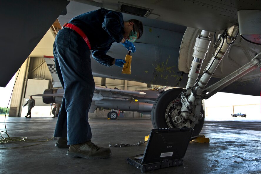 U.S. Air Force Airman 1st Class William Orlandi, 51st Aircraft Maintenance Squadron, Osan Air Base, Republic of Korea, crew chief, takes an oil sample while conducting a post flight check on a U.S. Air Force F-16C Fighting Falcon from the 36th Fighter Squadron, June 18, 2012, during Red Flag-Alaska 12-2 at Eielson Air Force Base, Alaska. Red Flag-Alaska is a Pacific Air Forces-sponsored, joint/coalition, tactical air combat employment exercise which corresponds to the operational capability of participating units. The entire exercise takes place in the Joint Pacific Range Complex over Alaska as well as a portion of Western Canada for a total airspace of more than 67,000 square miles. (U.S. Air Force photo/Tech. Sgt. Michael Holzworth)