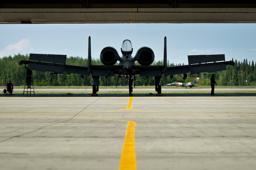 U.S. Air Force crew chiefs from the 51st Aircraft Maintenance Squadron, Osan Air Base, Republic of Korea, conduct post flight checks on a U.S. Air Force A-10 Thunderbolt II from the 25th Fighter Squadron, after a combat training mission June 18, 2012, during Red Flag-Alaska 12-2 at Eielson Air Force Base, Alaska. Red Flag-Alaska is a Pacific Air Forces-sponsored, joint/coalition, tactical air combat employment exercise which corresponds to the operational capability of participating units. The entire exercise takes place in the Joint Pacific Range Complex over Alaska as well as a portion of Western Canada for a total airspace of more than 67,000 square miles. (U.S. Air Force photo/Tech. Sgt. Michael Holzworth)