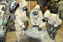 Reservists fom the 446th Airlift Wing here, train for contingency operations Jan. 8.  Their mission readiness training included donning protective gear and practicing decontamination procedures. Exercises like this will now have a guiding resource in the new 446th Airlift Wing Combat Readiness Office. (U.S. Air Force photo by Tech. Sgt. Elizabeth Moody)