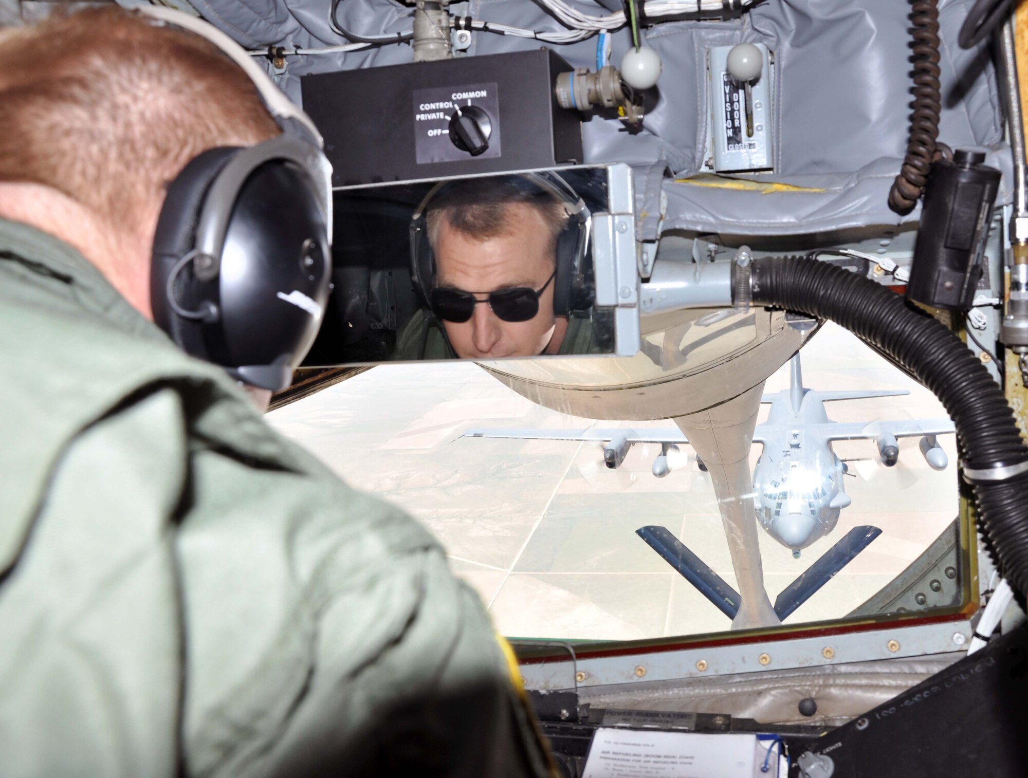 Master Sgt. James Guldjord, a refueling boom operator assigned to the 931st Air Refueling Group, McConnell Air Force Base, Kan., prepares to conduct an air refueling with an AC-130H Spectre gunship, assigned to the 27th Special Operations Wing, Cannon Air Force Base, N.M., June 21, 2012.  A film crew was on board the AC-130H during the mission to shoot footage for a Military Channel television program that will feature the gunship.  (U.S. Air Force photo by 1st Lt. Zach Anderson)  