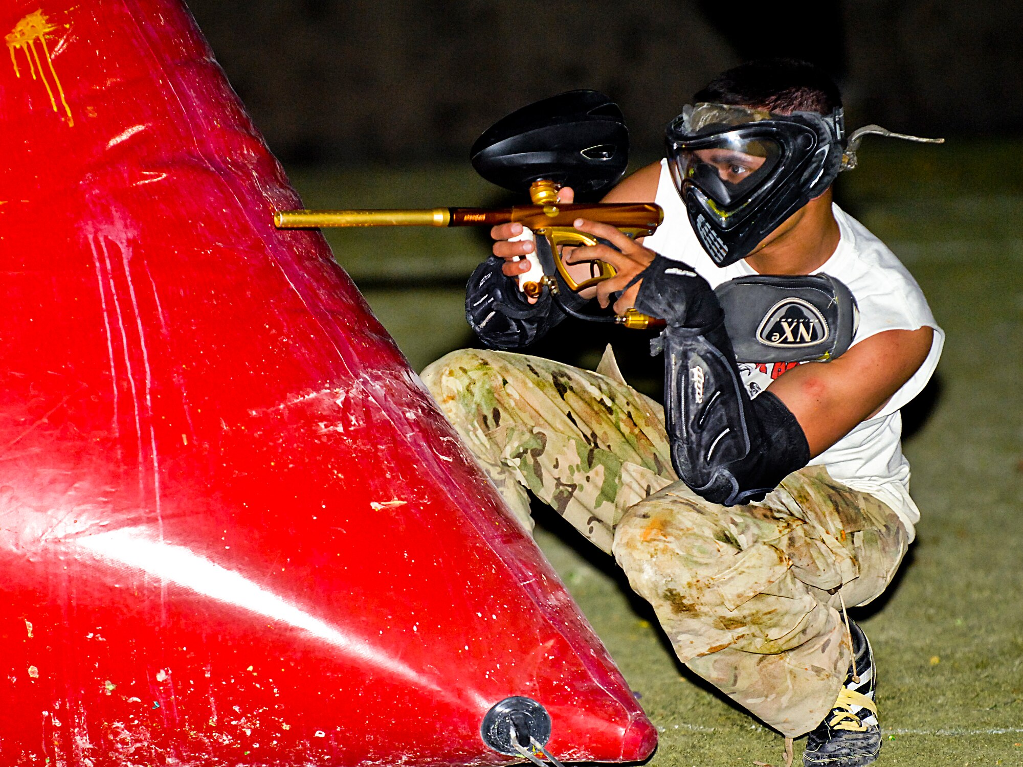 Senior Airman Daniel Middaugh, Nellis Air Force Base honor guard trainer, plays paintball as part of the Nellis Air Force Base chapel's outreach program event held June 8, 2012.  The chapel outreach program affords Airmen opportunities to get out and meet new people. This event had more than 100 attendees. (U.S. Air Force photo by Senior Airman Jack Sanders)
