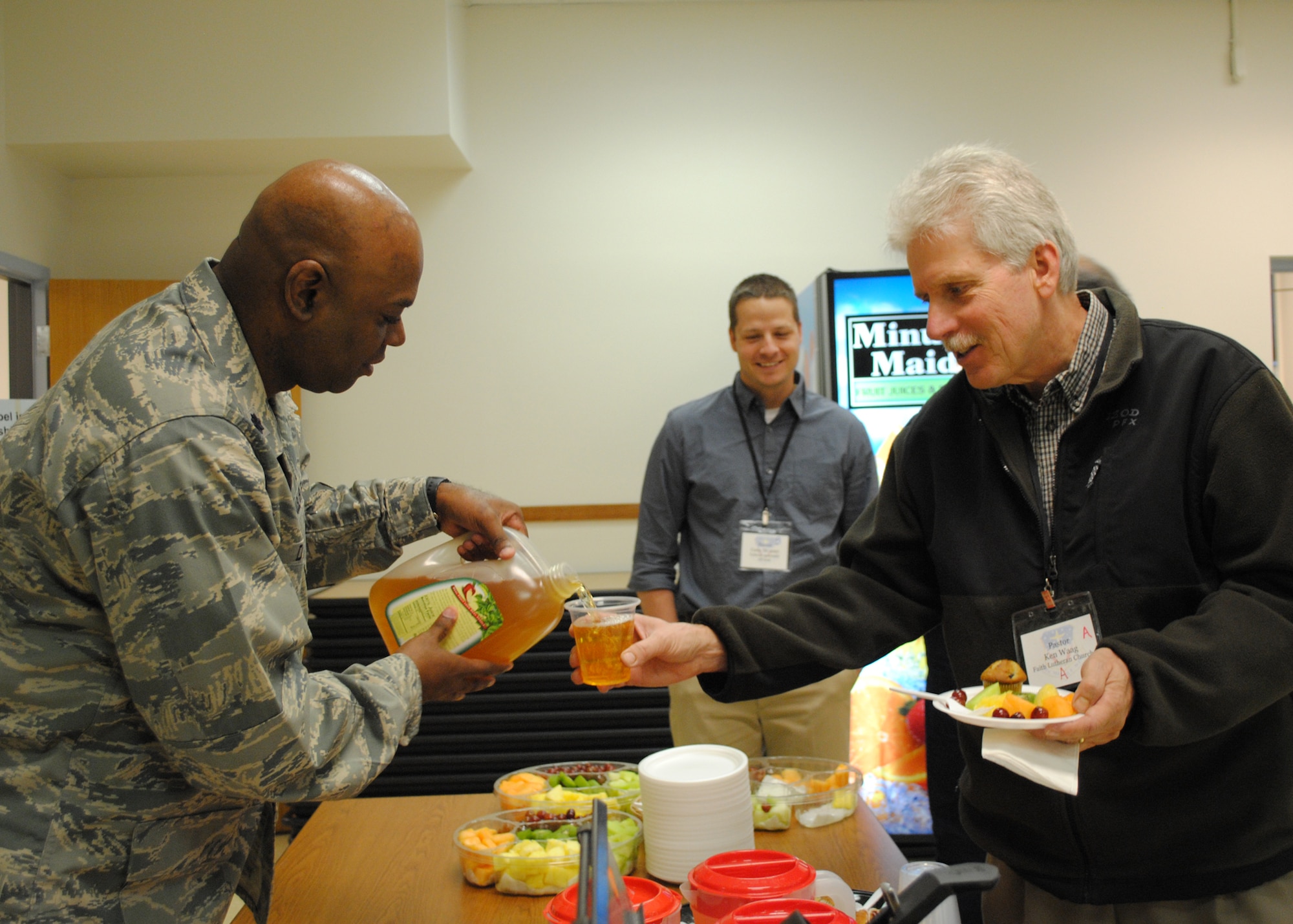 Chaplain (Lt. Col.) Clyde Dyson, 341st Missile Wing chaplain, pours apple juice for Ken Waag, Faith Lutheran Church of Great Falls pastor, at the Chapel Annex on June 19. More than 20 local religious leaders attended Malmstrom’s clergy day. Attendees took a tour of the chapel, Detour, missile procedures trainer and the base museum. (U.S. Air Force photo/Airman 1st Class Katrina Heikkinen)