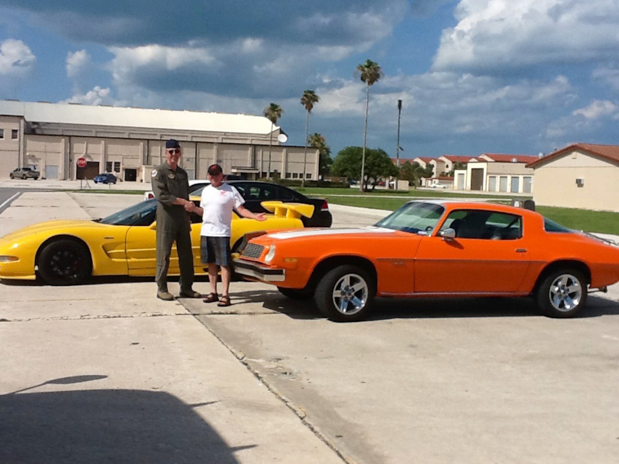 NASCAR racecar driver, Mr. Geoff Bodine, greeted 920th Rescue Wing Airmen at Patrick Air Force Base, Fla., June 2 during the 920th RQW Family & Employer Appreciation Day. After spending time with Rescue Warriors and signing autographs, he spotted Col. Jeffrey Macrander's (the wing commander) classic Camaro and stopped to get a photo of his Corvette next to it, but was caught in the act by the colonel. Macrander is an HH-60G Pave Hawk pilot. During a NASCAR race, cars can reach speeds up to 200 MPH, which is also the speed of a Pave Hawk. When it comes to the performance of Caeros and Corvettes, there are mixed opinions on which car  can outperform the other.  (Courtesy photo)

