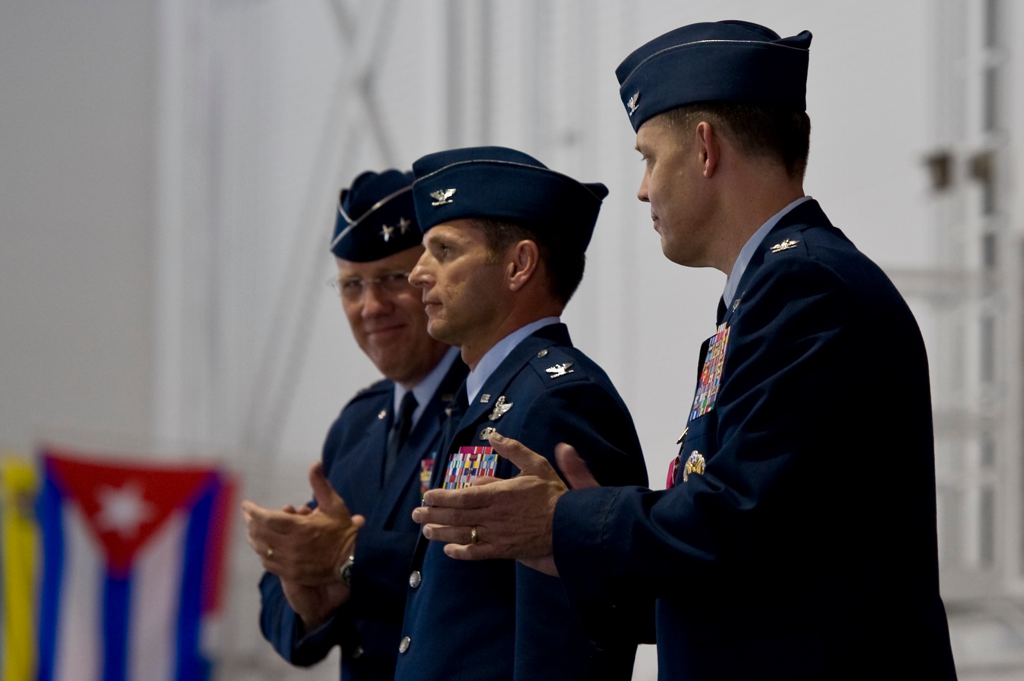 U.S Air Force Maj. Gen. Bill Hyatt, U.S. Air Force Warfare Center commander and Brig. Gen. (select) Garland, previous 99th Air Base Wing commander, congratulate Col. Barry Cornish upon his taking command of the 99th Air Base Wing June 15, 2012, at Nellis Air Force Base, Nev. Cornish entered the Air Force in 1990 as a distinguished graduate of the University of North Texas Reserve Officer Training Corps program. He is a command pilot with more than 2,200 flying hours, and is a graduate of the USAF Weapons School. (U.S. Air Force photo by Airman 1st Class Christopher Tam)