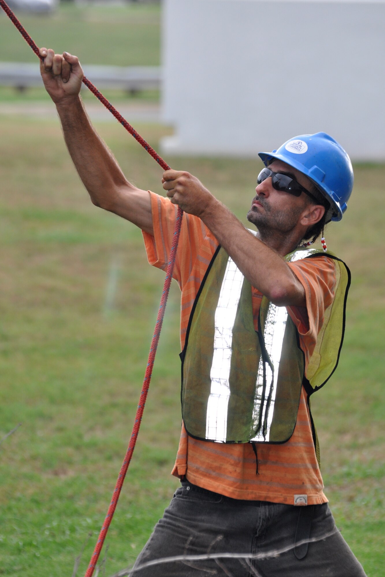 Tommy Swieter, a landscaping specialist for Rushing Technical Services, Cabot Ark., keeps tension on a rope tied to a limb on a dead tree at the 307th Bomb Wing Headquarters building on Barksdale Air Force Base, La., June 19, 2012. Swieter’s hold on the rope will keep the limb from falling into power lines once the cut is made. Due to the 2011 drought season and the warmest spring on record, hundreds of trees on Barksdale have died. Efforts are being made to clear the trees on the main base and in the housing areas. To date, workers for RTS have cleared approximately 30 trees off the main base. (U.S. Air Force photo by Master Sgt. Jeff Walston)  