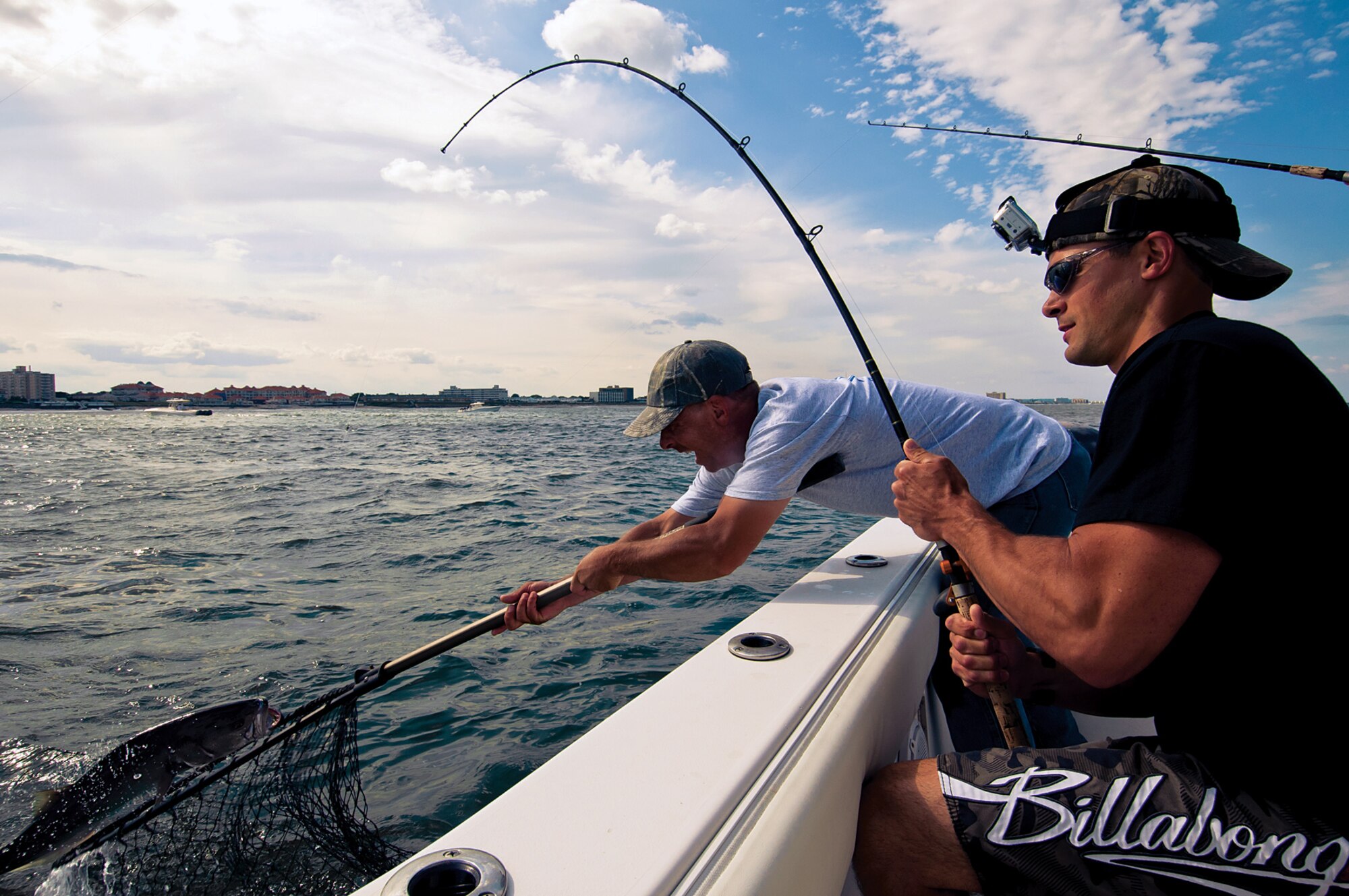 Staff Sgt. Ryan Miller, 514th Maintenance Squdron, reels in a striped bass during an off-shore fishing trip near Asbury Park, N.J., June. Miller runs a charitable organization that sets up low cost or no cost fishing and hunting trips for veterans,actively serving military personnel and other public servants such as police officers and firefighters. (U.S. Air Force photo by Shawn J. Jones)
