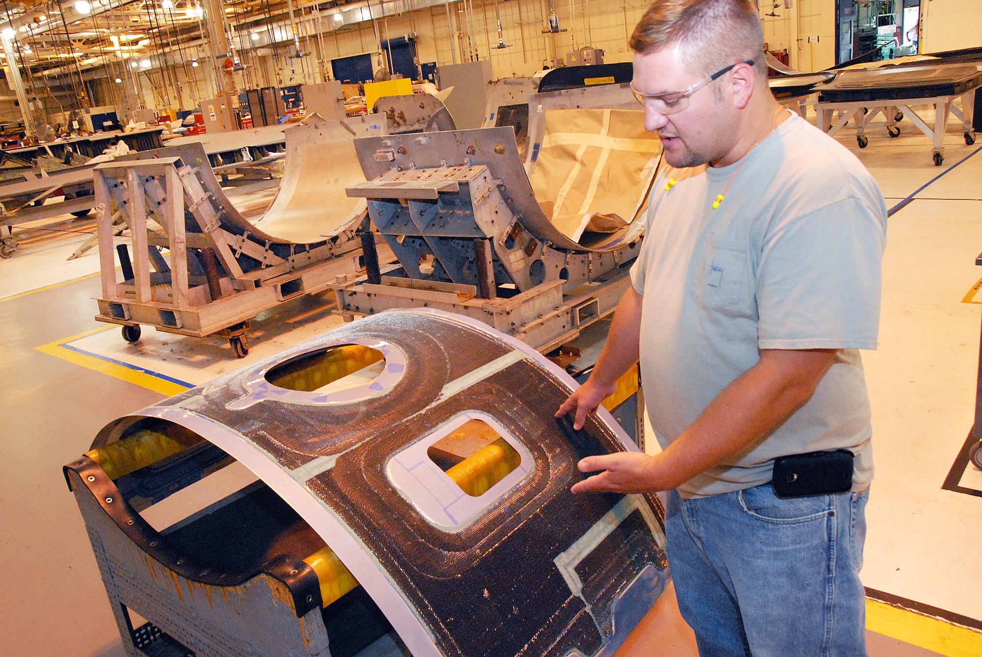 Wesley Wood shows a C-5 cowling  in production in the shop. (U. S. Air Force photo by Sue Sapp)