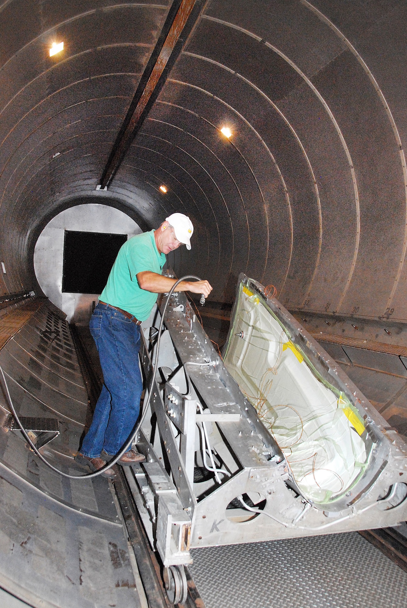 Michael Vaugh positions the nose for a C-5 pylon in the large autoclave in Bldg. 169. (U. S. Air Force photo by Sue Sapp)