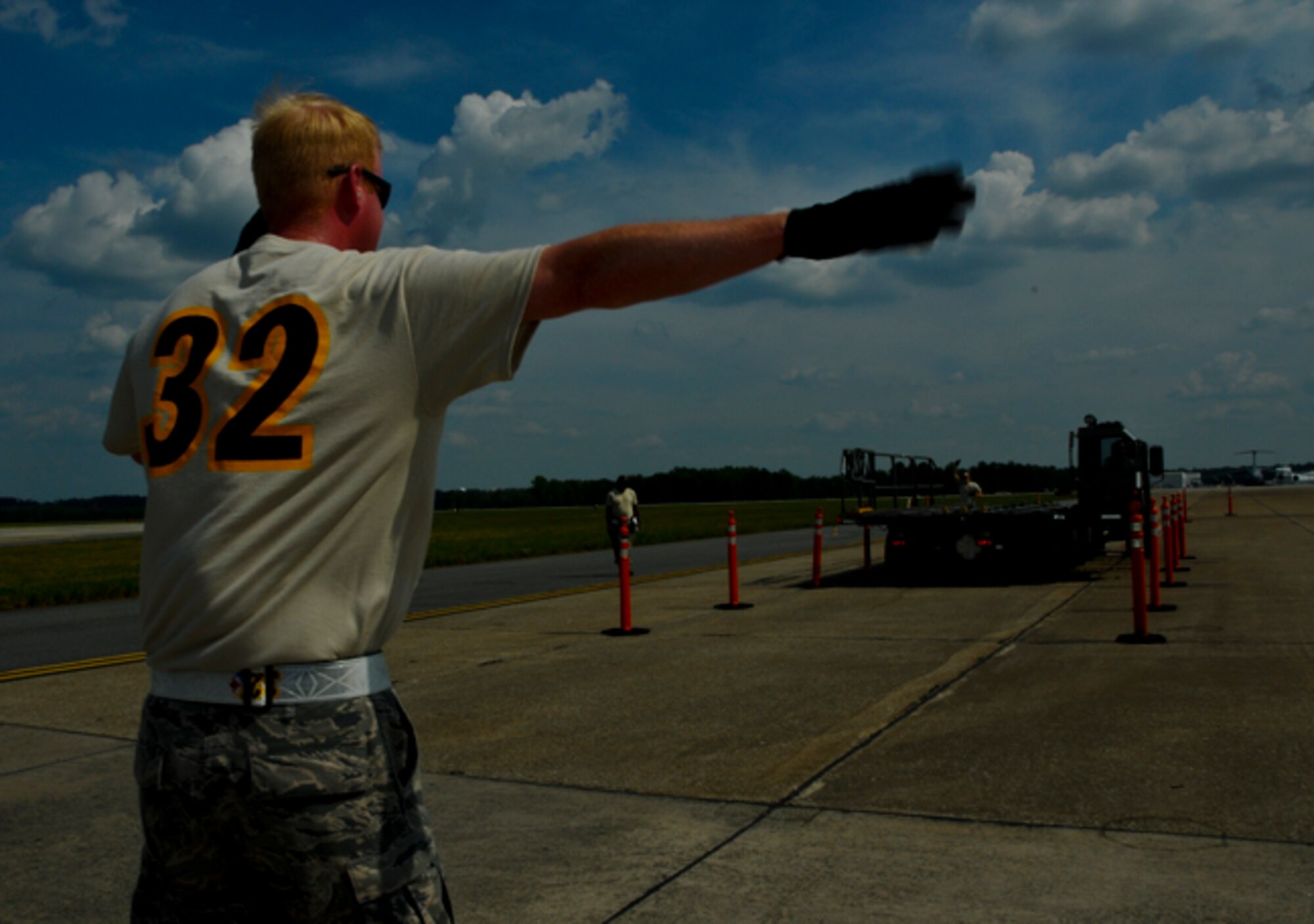 Master Sgt. Robert Steckmeyer, 32nd Aerial Port Squadron air transportation specialist, spots a 25K Halvorsen aircraft loader as part of the 25k obstacle course event during the Port Dawg Challenge competition at Dobbins Air Reserve Base, Ga., June 20, 2012. The obstacle course is designed to simulate the transportation of pallets to and from aircraft using the 25K Halvorsen. Teams were given 30 minutes to complete the course and were judged on correct usage of spotting signs, safe driving and timeliness on the simulated on-loading and off-loading of pallets to the aircraft. (U.S. Air Force photo by Senior Airman Joshua J. Seybert/Released)