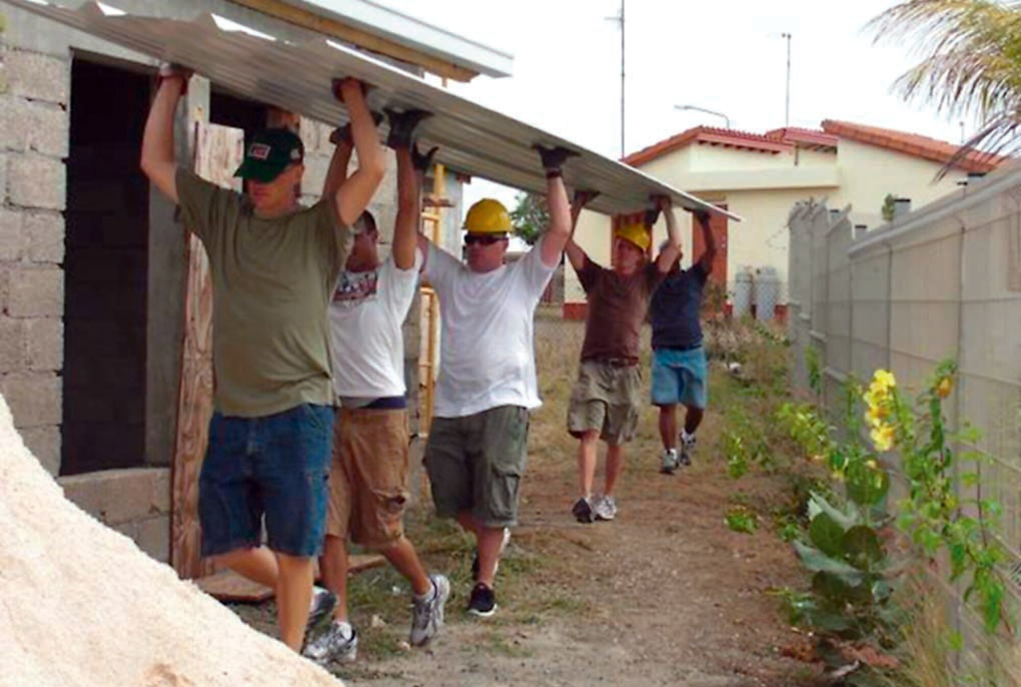 Members of the 912th Air Refeuling Squadron assist in building the roof of an elderly home as part of the Nos Welita project. (U.S. Air Force photo by Capt. Josh Chambers)