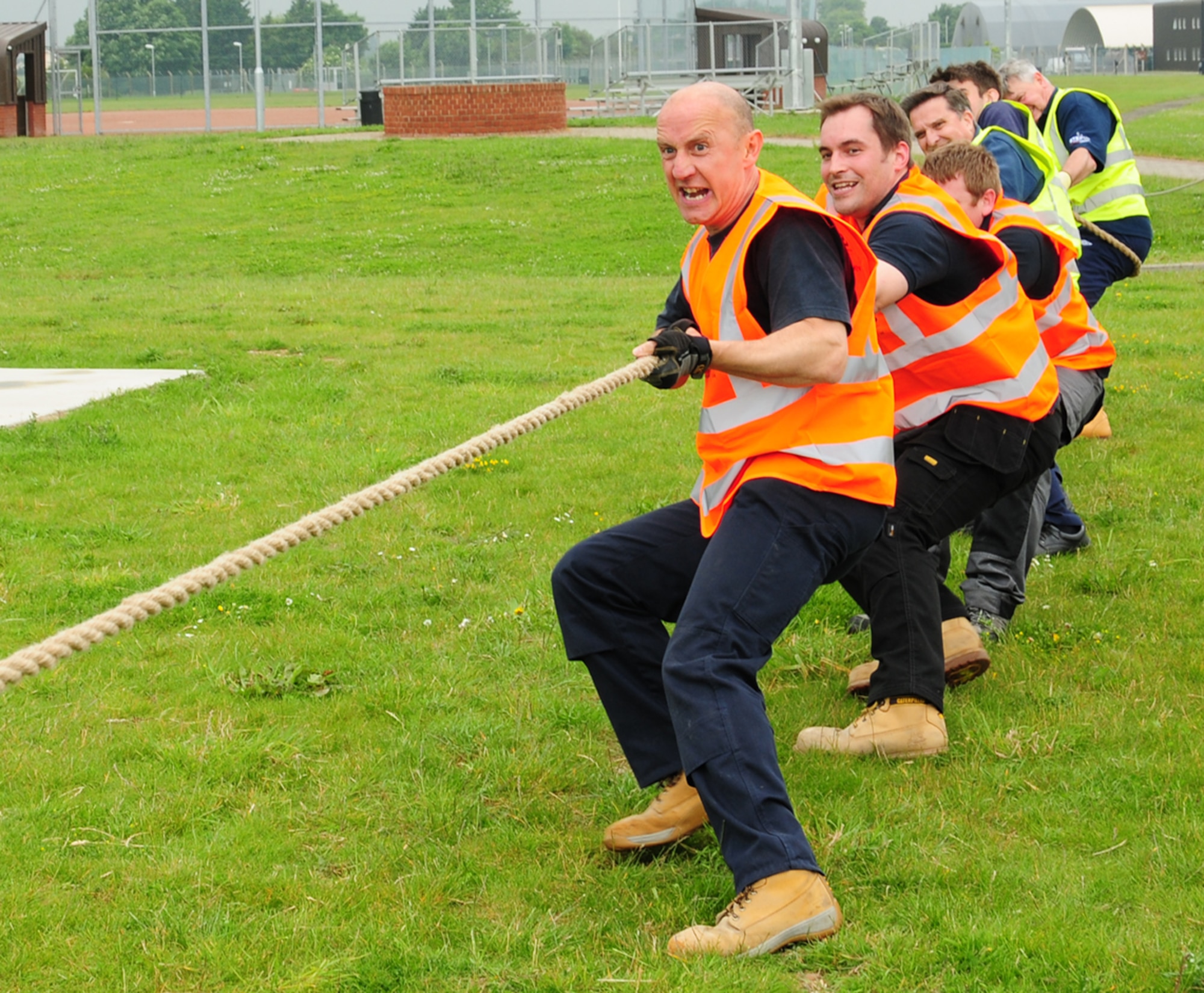 RAF MILDENHALL, England -- A team of contractors dig their heels in to steady themselves as they pull away from the opposing team from the 100th Mission Support Group during a tug-of-war at the Marauder Melee event June 21, 2012, at RAF MIldenhall. The contractors beat the 100th MSG 2-0. Team Mildenhall members braved the rain as they participated in the ‘Marauder Melee’ at RAF Mildenhall. The event started with a 100th Air Refueling Wing run, in formation, on the taxiway behind Hangar 814. Other events took place throughout the base, including dodgeball, volleyball, a fitness challenge and an obstacle race. To round the day off, family-fun events were held for children, with activities such as a kids’ ‘Olympics,’ games, wiggle kart track, and a mascot race between Sparky the Fire Dog, Max the Monkey and others. (U.S. Air Force photo by Karen Abeyasekere)