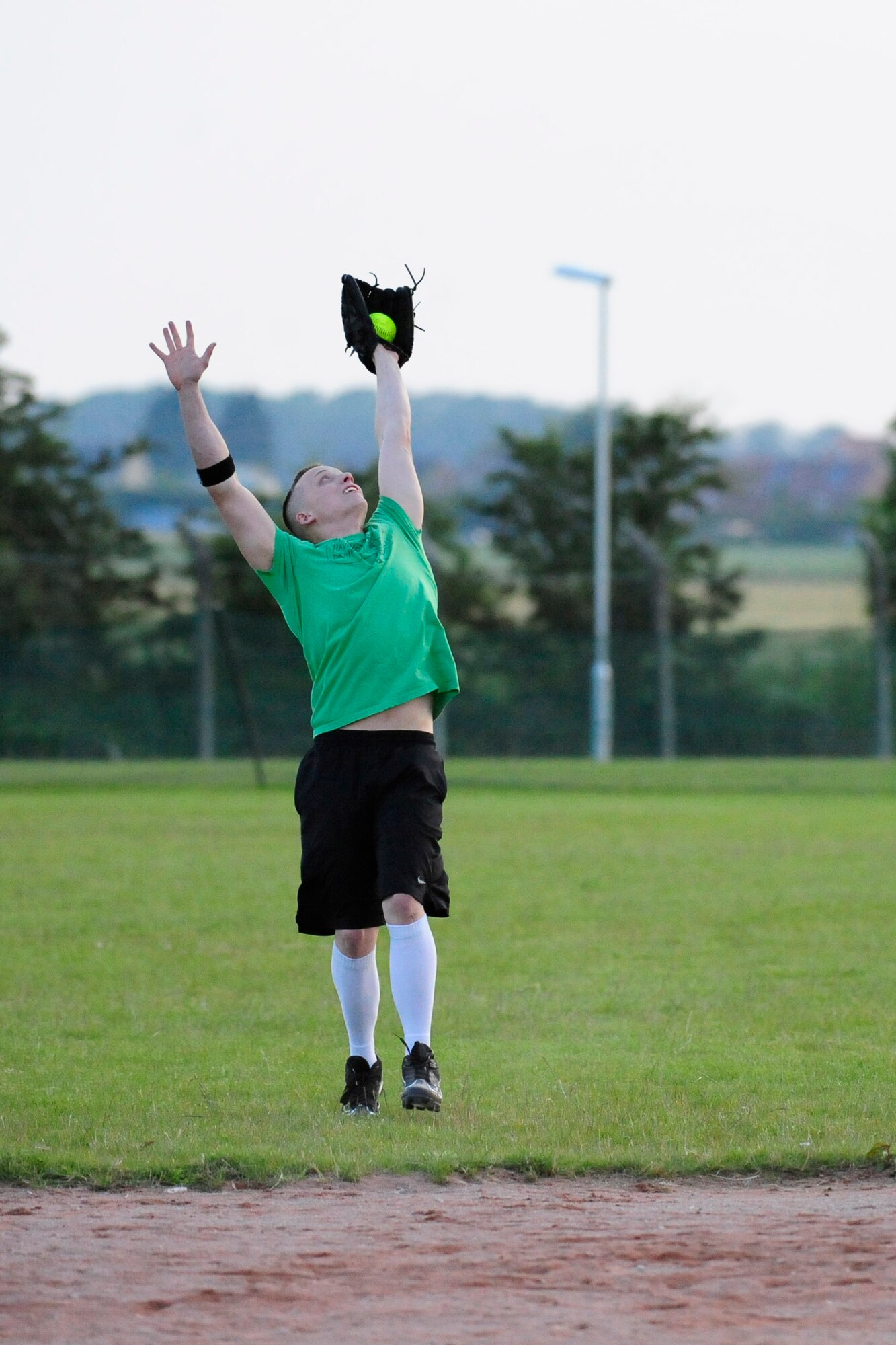 RAF MILDENHALL, England – Gregory Barker, 100th Aircraft Maintenance Squadron, catches a pop-up during an intramural softball game against the 100th Communications Squadron at RAF Mildenhall June 20, 2012. The 100th AMXS won the game with a final score of 14 to 12. (U.S. Air Force photo/Senior Airman Ethan Morgan)