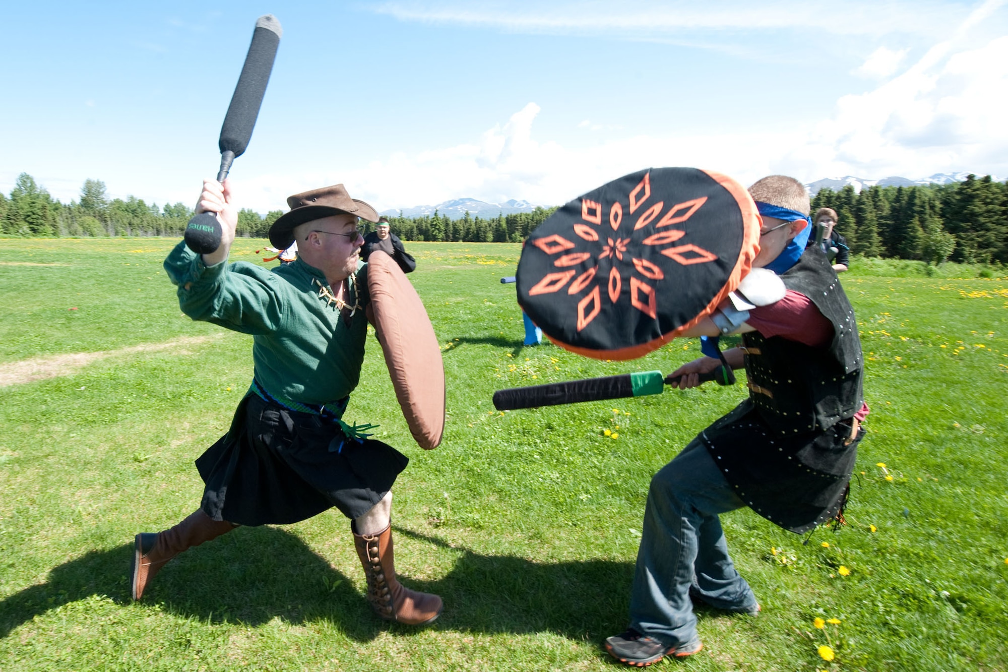 Matthew Sisk, a military spouse, other military affiliated and civilians in the Anchorage community engage in mock medieval battle with foam swords during a Lupine Moon meeting at Russian Jack Park in Anchorage, Alaska June 16. More than 50 people participated at the Amtguard grouping, which also includes various crafts such as chain mail knitting, with approximately one in five military. (U.S. Air Force photo/Staff Sgt. Robert Barnett)