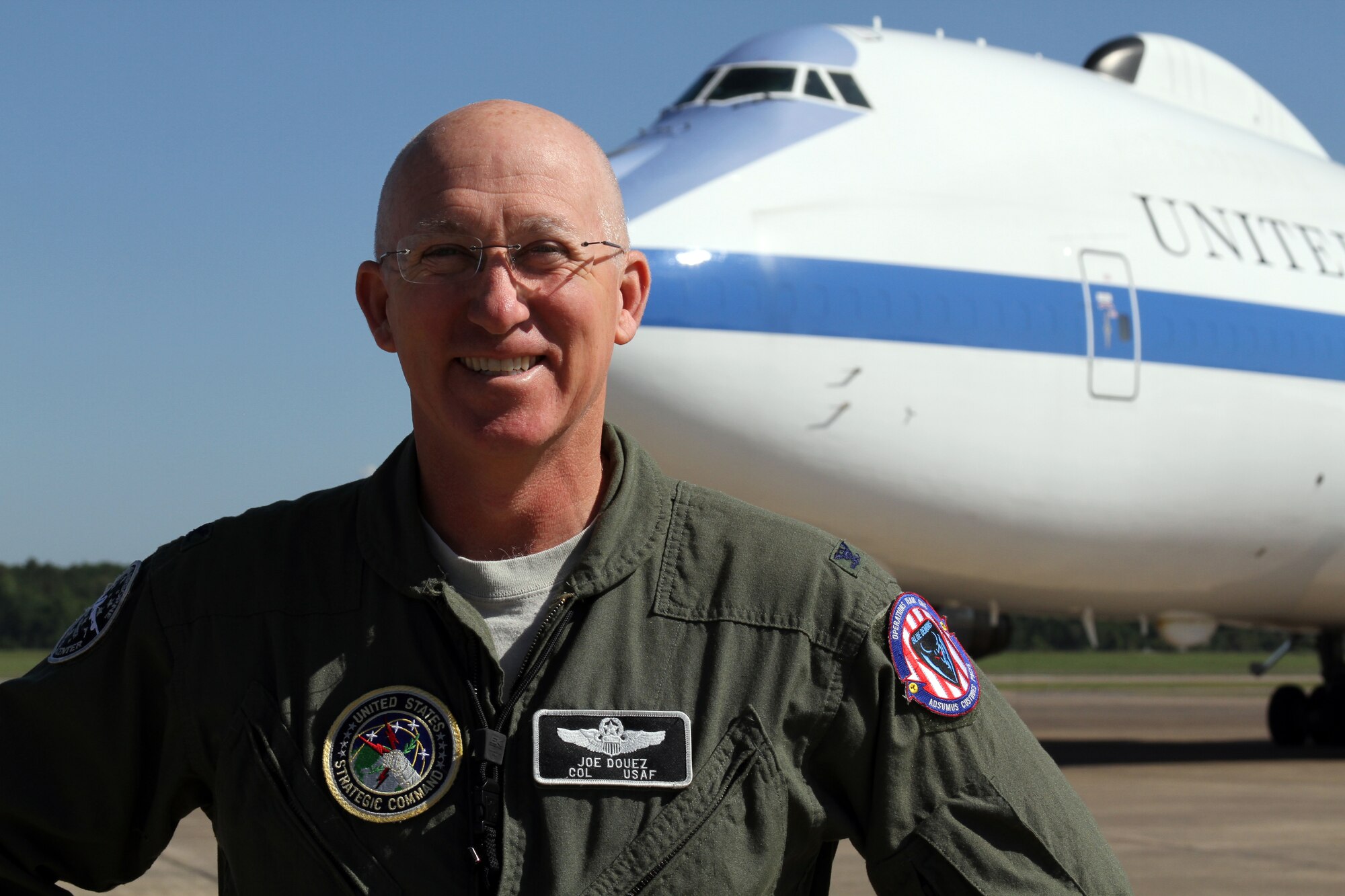 U.S. Air Force Col. Joe Douez poses next to an E-4B as the new National Airborne Operations Center commander at Offutt Air Force Base, Neb. Douez took command from Navy Capt. Scott Ryder during a ceremony here May 4. The NAOC consists of a 92-member joint alert force that is responsible for executing crisis decisions of the president, secretary of defense and chairman Joint Chiefs of Staff for command and control of military forces across the entire threat spectrum. (Photo by U.S. Air Force Maj. Rafael Vargas)
