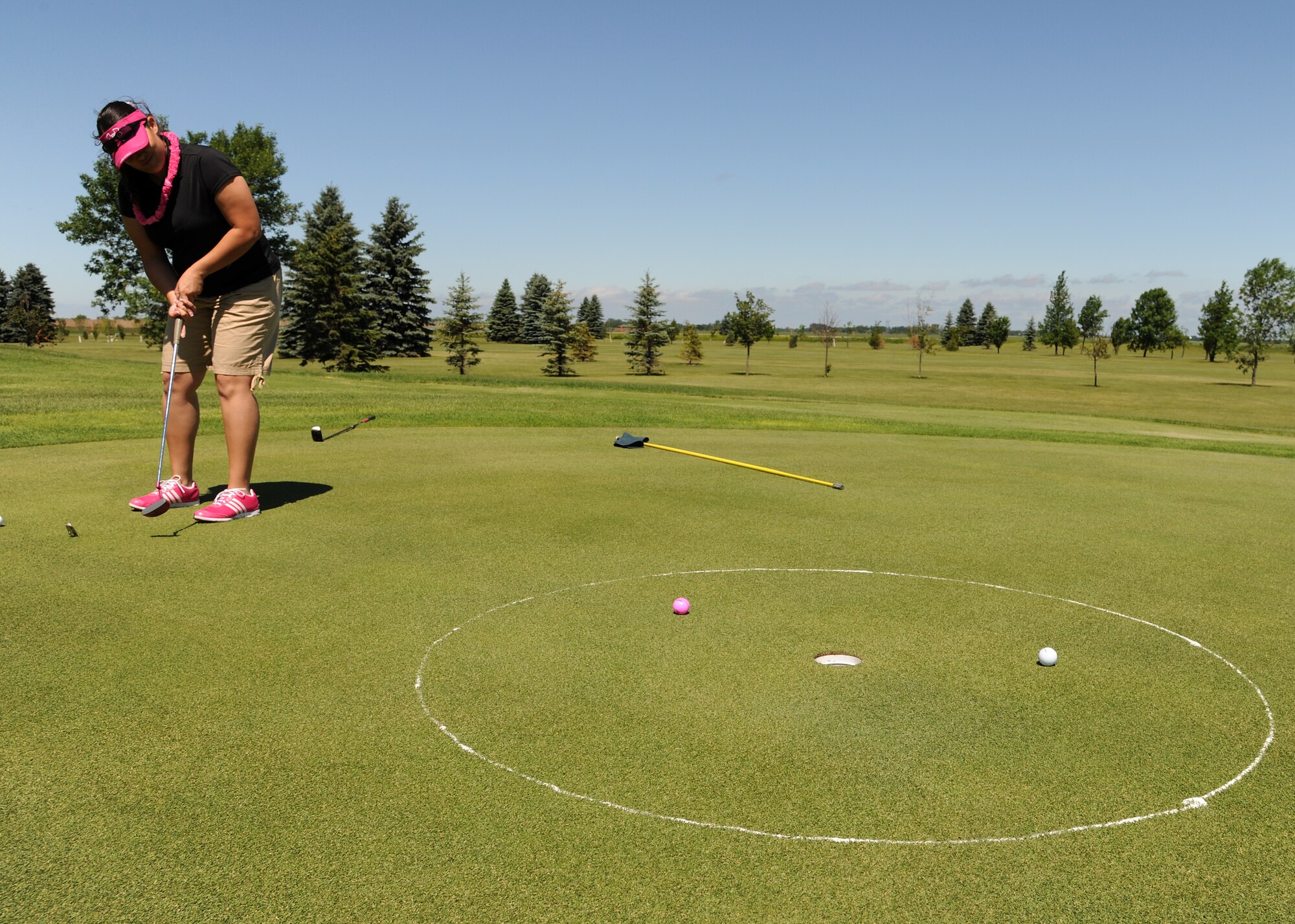 Staff Sgt. Vanessa Glenn, 319th Mission Support Group, attempts a putt during the annual Military Affairs Committee golf tournament on June 18, 2012, on Grand Forks Air Force Base, N.D. (U.S. Air Force photo/Airman 1st Class Ashley N. Taylor)