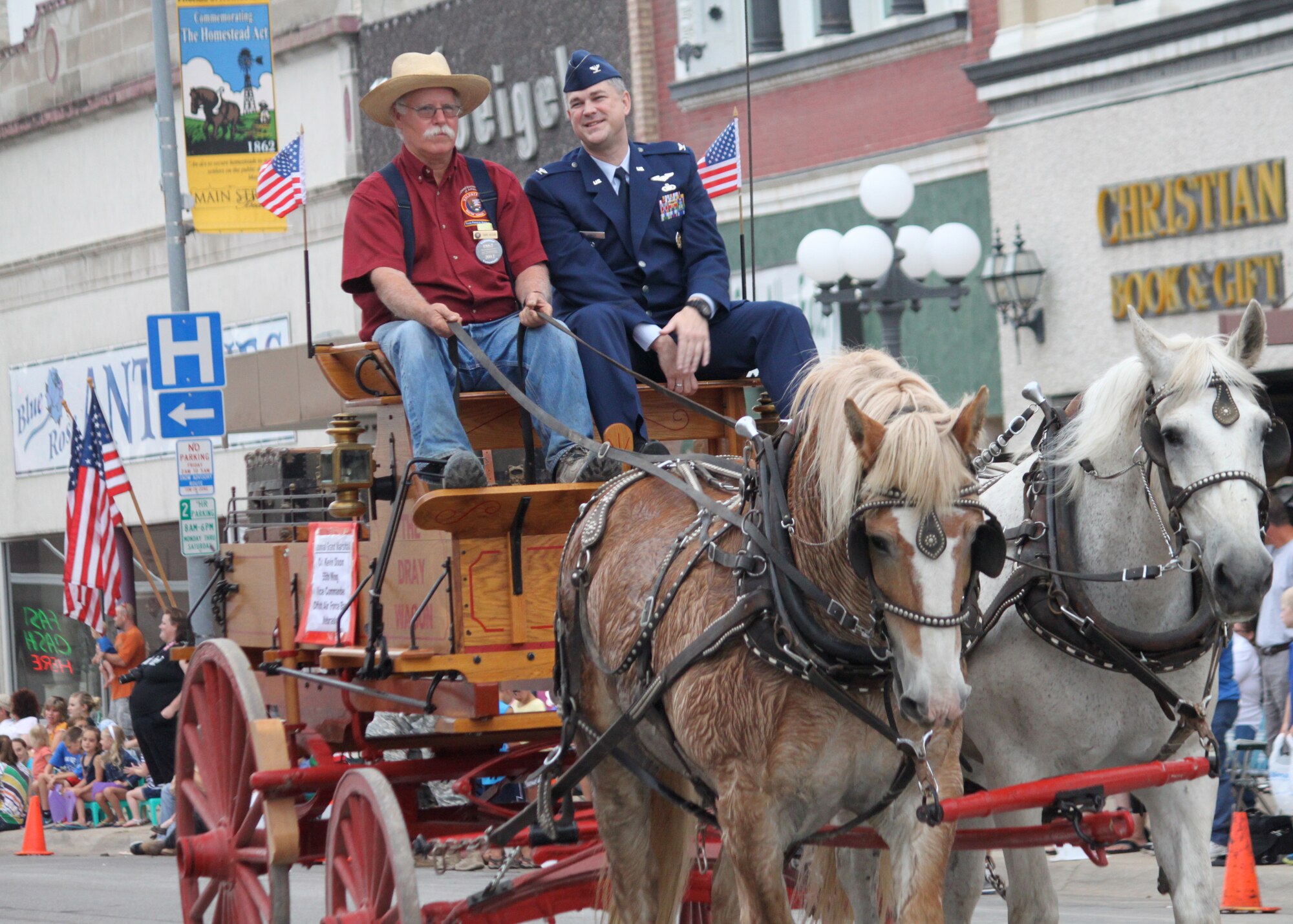 Col. Kevin Dixon, 55th Wing vice commander, rides through downtown Beatrice, Neb., as the grand marshal of the 29th Annual Homestead Days parade along with Gary Higgins, a long-time Homestead Volunteer Ranger Corp member, June 16. Dixon also spoke at a ceremony commemorating 150 years of the Homestead Act, which was one of three federal laws that gave an applicant ownership at no cost of farmland called a “homestead” – typically 160 acres of undeveloped federal land west of the Mississippi River. (Courtesy photo)