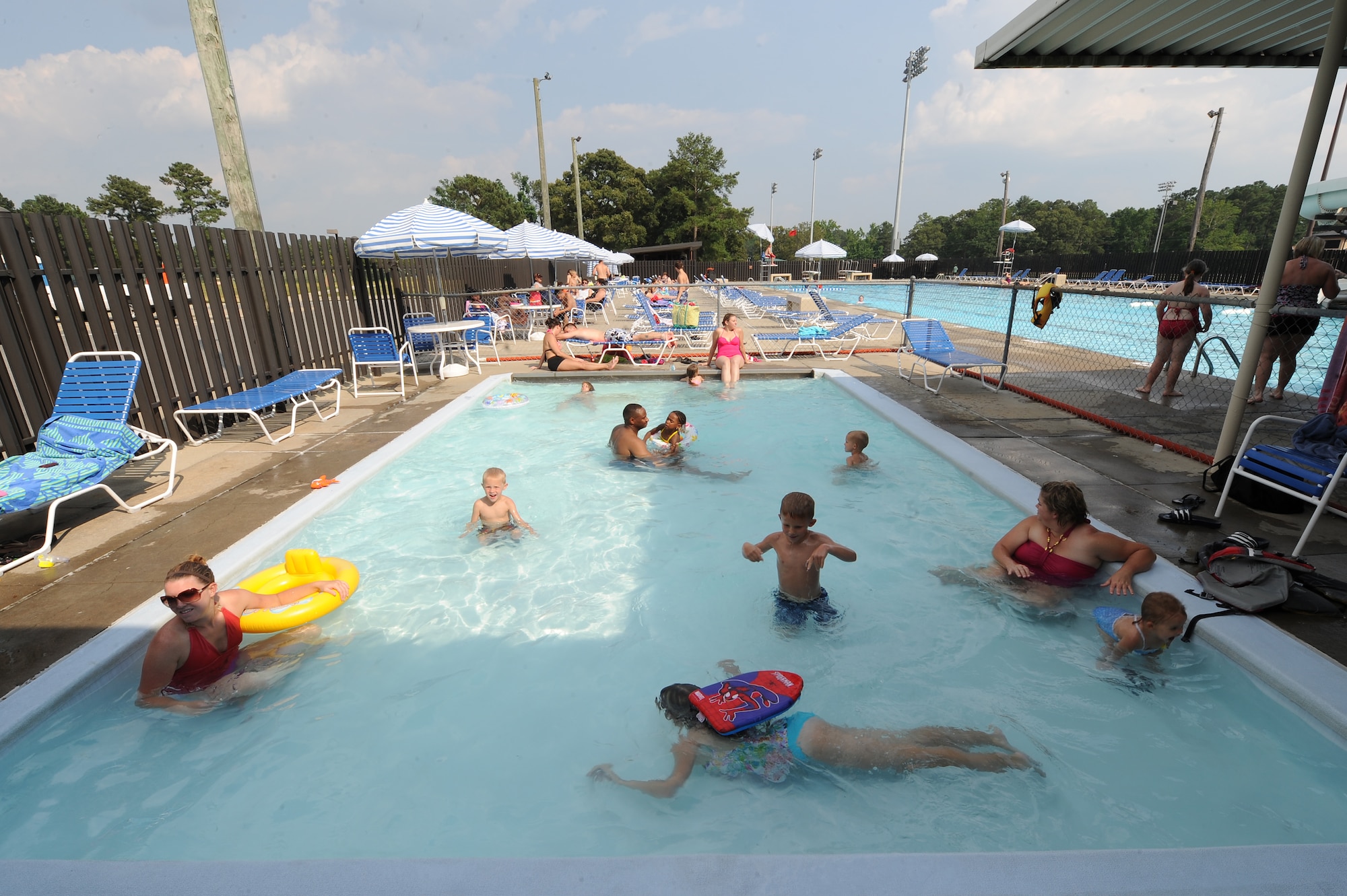 Adults and children swim in the wading pool on Seymour Johnson Air Force Base, N.C., June 19, 2012. The wading pool is for children 5 years of age or younger and their supervising adults. (U.S. Air Force photo/Airman 1st Class John Nieves Camacho/Released)
