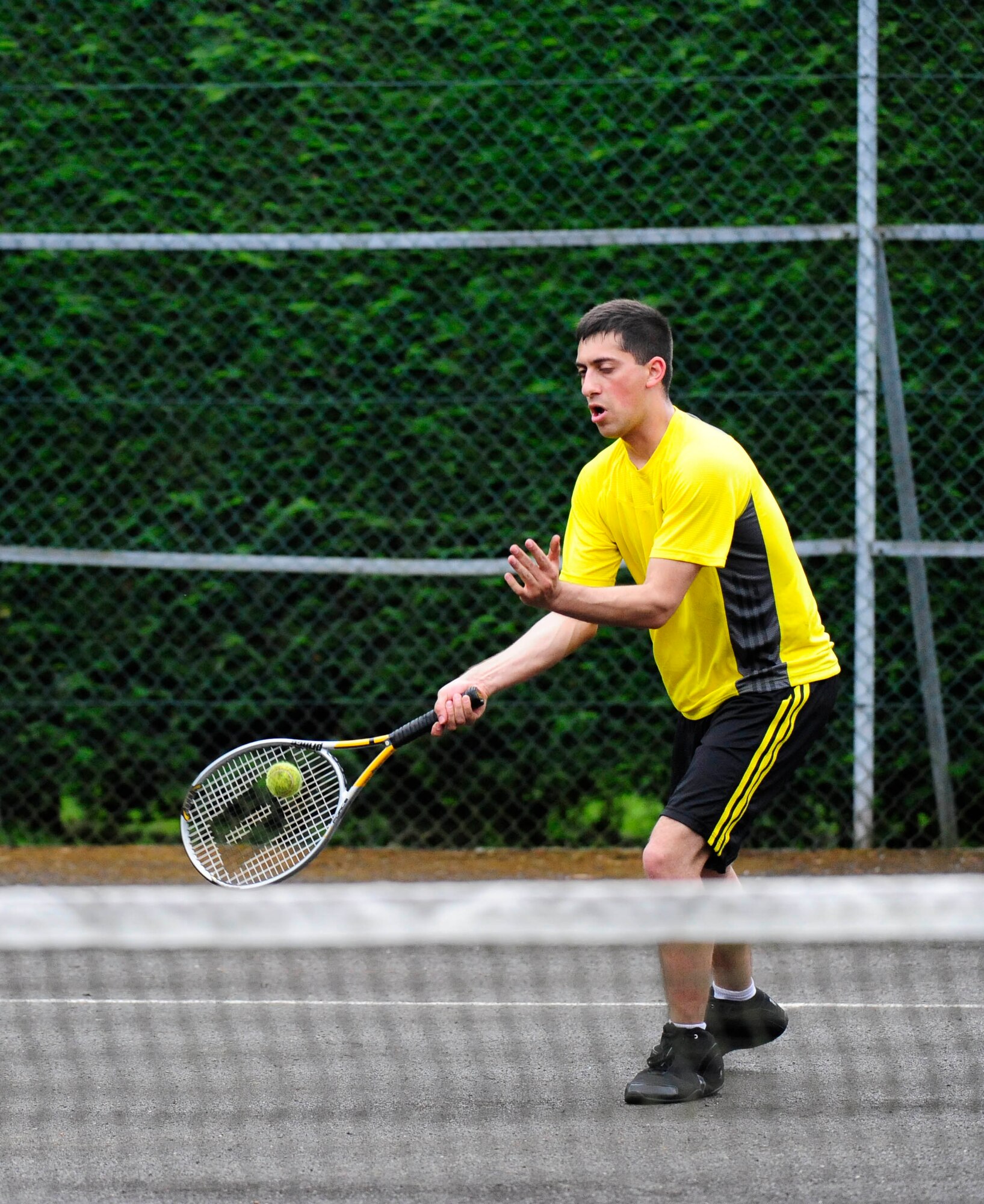 RAF MILDENHALL, England – Gregory Gavia, 100th Security Forces Squadron, returns a serve during a tennis match that was part of the ‘Marauder Melee’ at RAF Mildenhall June 21, 2012. The event started with a 100th Air Refueling Wing run, in formation, on the taxiway behind Hangar 814. Other events took place throughout the base, including dodgeball, volleyball, a fitness challenge and an obstacle race. (U.S. Air Force photo/Senior Airman Ethan Morgan)