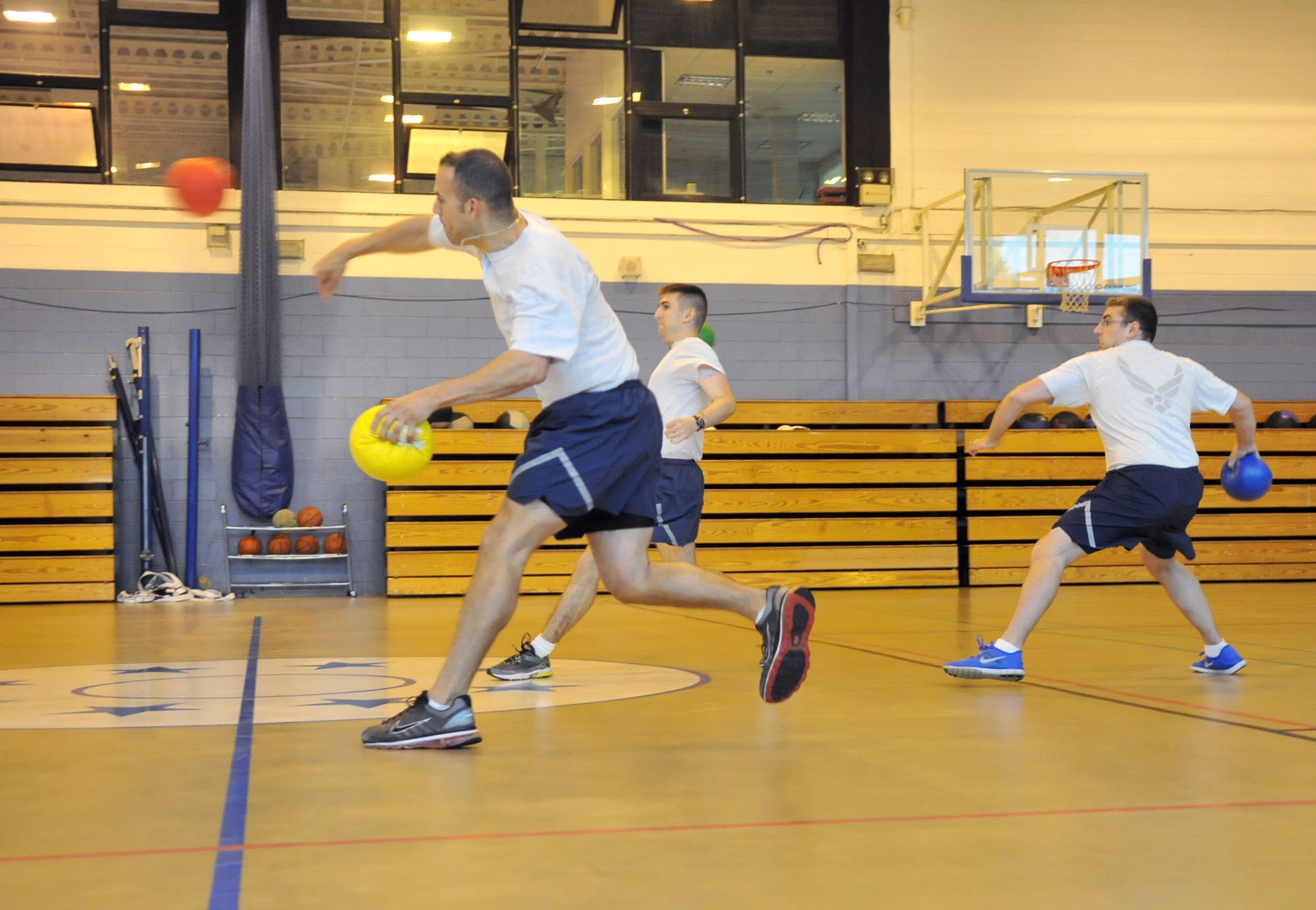RAF MILDENHALL, England – Airmen from the 100th Operations Support Squadron compete in the dodgeball challenge at the North Side Fitness Center here June 21, 2012. The challenge was one of several sporting events held as part of the Marauder Melee event. Other sporting events included volleyball, ping pong, tennis and an obstacle course. (U.S. Air Force photo/Senior Airman Jerilyn Quintanilla)