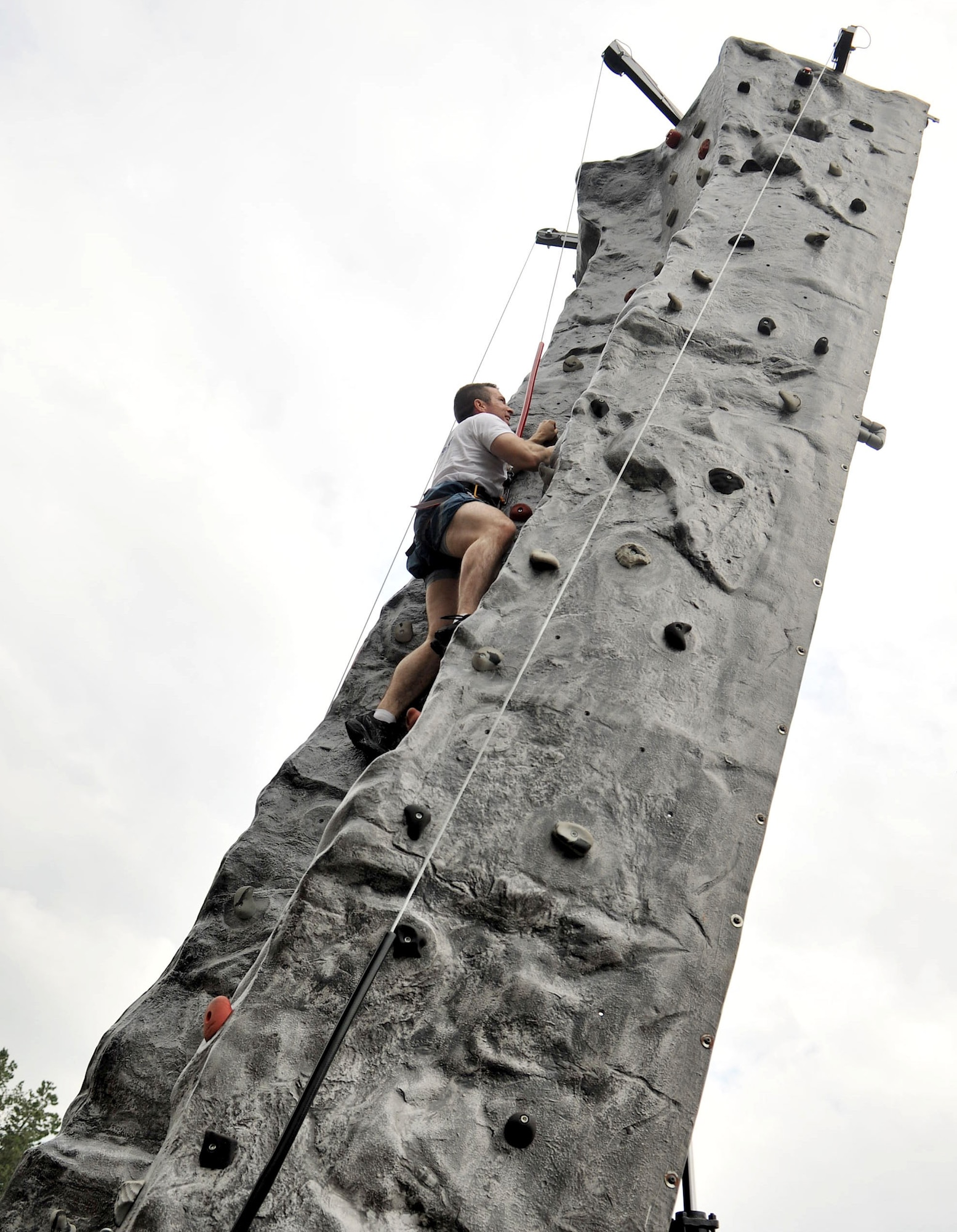 RAF MILDENHALL, England – Staff Sgt. Jessie Furse, 100th Civil Engineer Squadron, climbs the rock wall as part of the rock climbing challenge during the Marauder Melee event at Heritage Park here June 21, 2012. Other events took place throughout the base, including dodgeball, volleyball, a fitness challenge and an obstacle race. Family-fun events were held for children, with activities such as kids’ ‘Olympics,’ games and a wiggle kart track. (U.S. Air Force photo/Senior Airman Jerilyn Quintanilla)