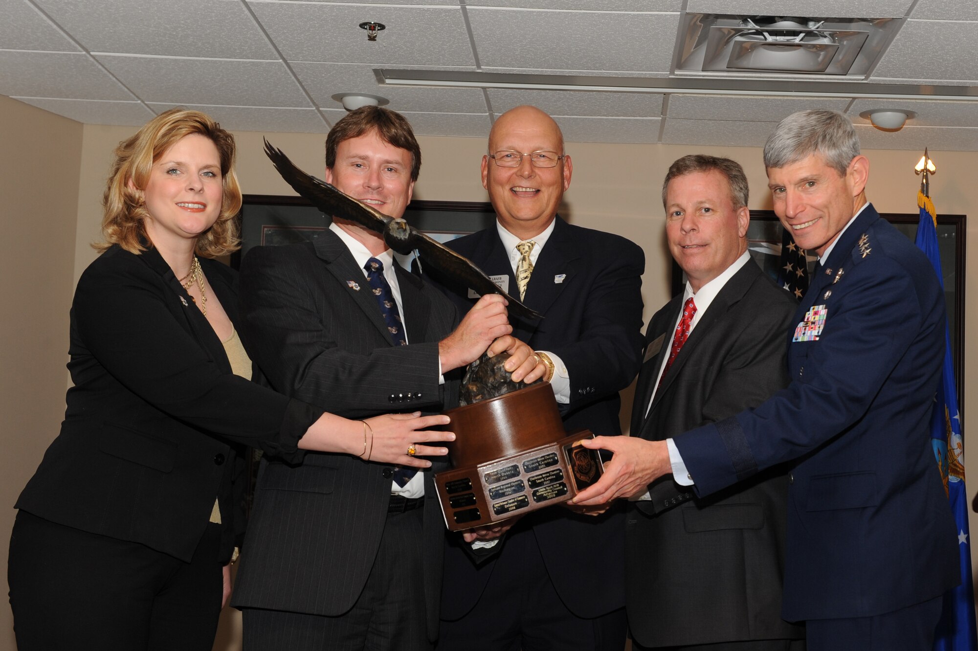 (Left to right) Ms. Kristina Jones and Mr. Gray Bridwell, Abilene Chamber representatives, presented the 2011 Abilene Trophy to Mr. Larry Biernacki, Little Rock Air Force Base Community Council president, Mr. Jay Chesshir, Little Rock Air Force Base Community Council past president, and Air Force Chief of Staff Gen. Norton Schwartz during the LRAFB Community Council general membership luncheon on June 20, 2012, at Little Rock Air Force Base, Ark.  (RELEASED U.S. Air Force photo by Tech. Sgt. Chad Chisholm)