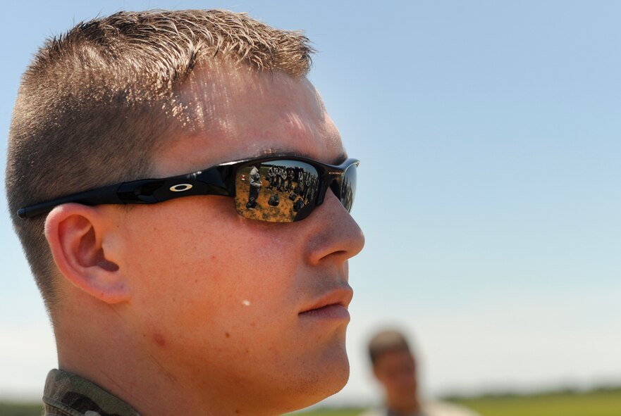 U.S. Air Force Senior Airman Derek Halverson, 824th Base Defense Squadron fire team member, listens to a speech after a static line jump at Henry Tift Myers Airport, Ga., June 19, 2012. Completing this jump was Halverson’s final requirement to obtain his Senior Parachutist Badge. (U.S. Air Force photo by Airman 1st Class Douglas Ellis/Released)
