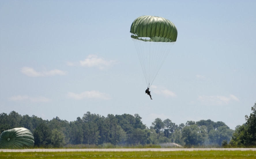 U.S. Air Force Senior Airman Derek Halverson, 824th Base Defense Squadron fire team member, parachutes from an HC-130P Combat King at Henry Tift Myers Airport, Ga., June 19, 2012. Seventeen Airmen participated in the static line jump to maintain their qualifications. (U.S. Air Force photo by Airman 1st Class Douglas Ellis/Released)
