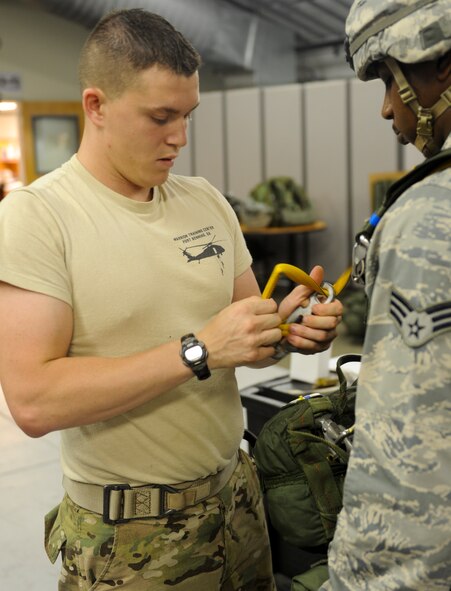 U.S. Air Force Senior Airman Derek Halverson, 824th Base Defense Squadron fire team member, performs a buddy check at Moody Air Force Base, Ga., June 19, 2012. One of the duties of a jumpmaster is to ensure all jumpers and their gear are ready for the jump. (U.S. Air Force photo by Airman 1st Class Douglas Ellis/Released) 
