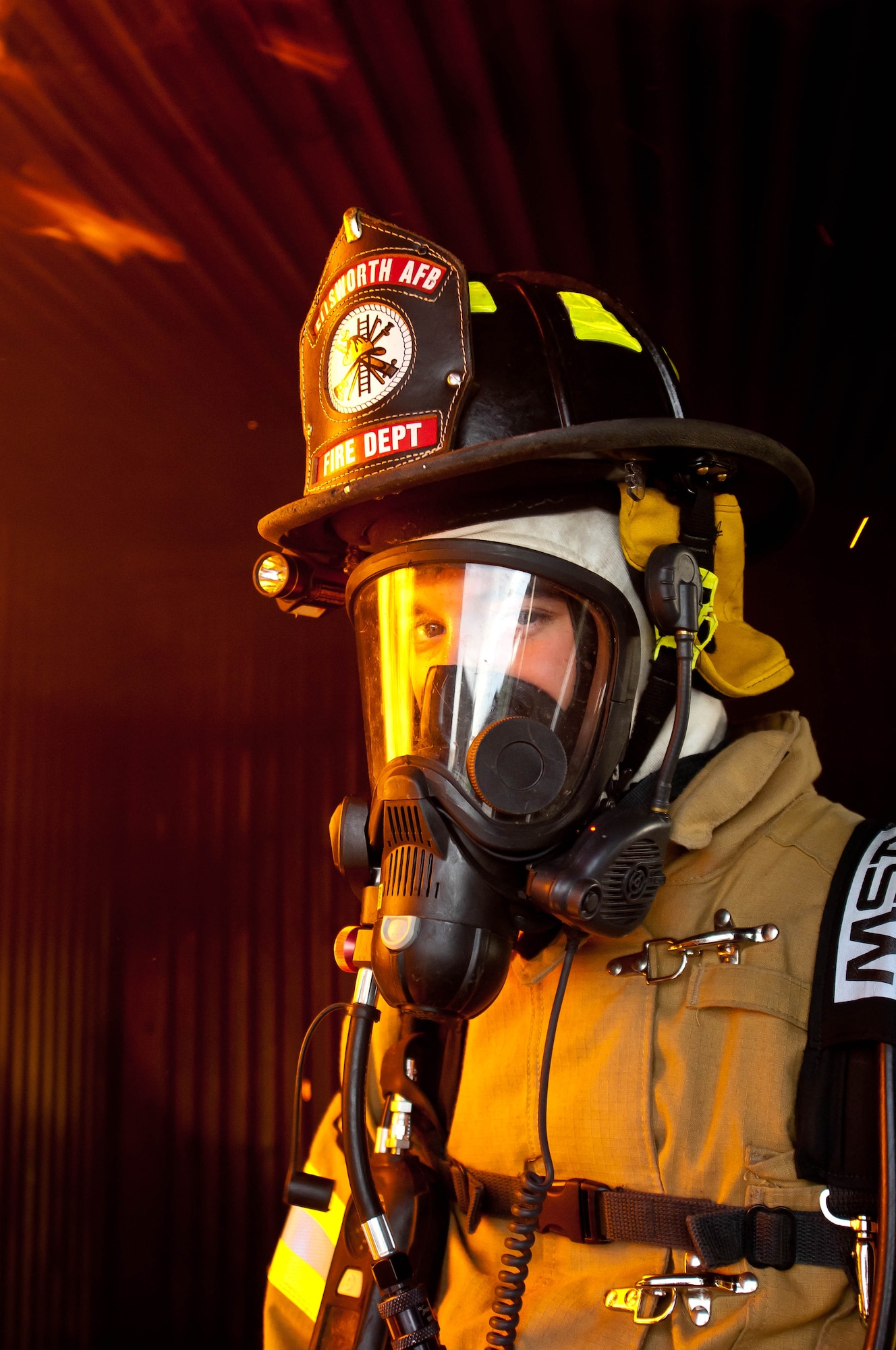 Airman 1st Class James Blair, 28th Civil Engineer Squadron fire protection specialist, prepares for an indoor simulated fire scenario during a joint training exercises at Ellsworth Air Force Base, S.D., June 18, 2012. The exercise allows firefighters to safely practice extinguishing fires and hone their fire response skills. (U.S. Air Force photo by Airman 1st Class Zachary Hada/Released)