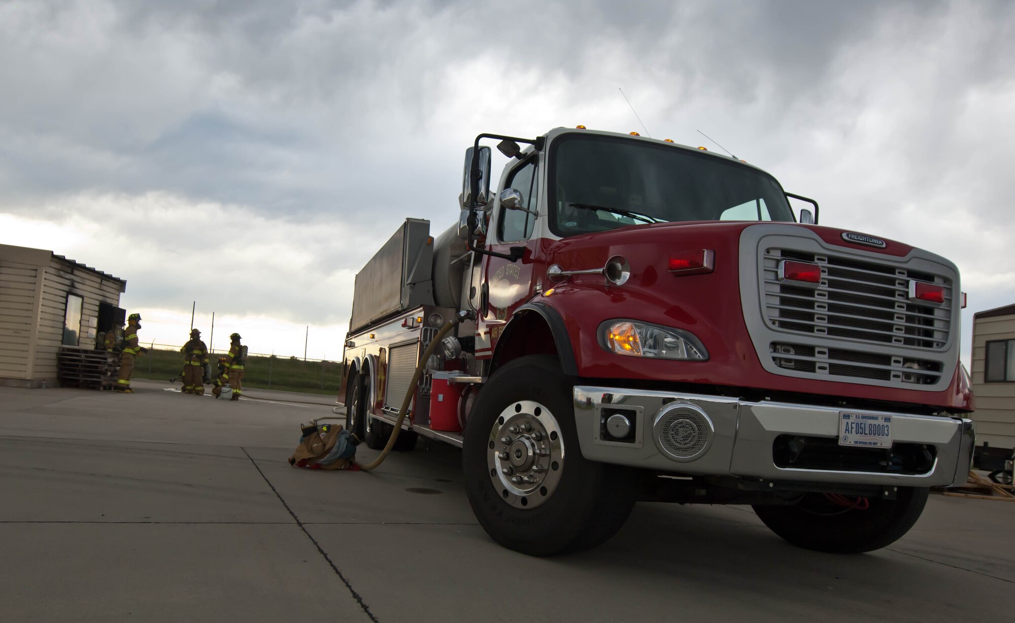 A fire response vehicle waits silently outside of the structural burn training facility during the 2012 Golden Coyote fire training exercise at Ellsworth Air Force Base, S.D., June 18, 2012. Soldiers from several Army National Guard units and 28th Civil Engineer Squadron firefighters conducted joint fire protection exercises throughout the week. (U.S. Air Force photo by Airman 1st Class Zachary Hada/Released)